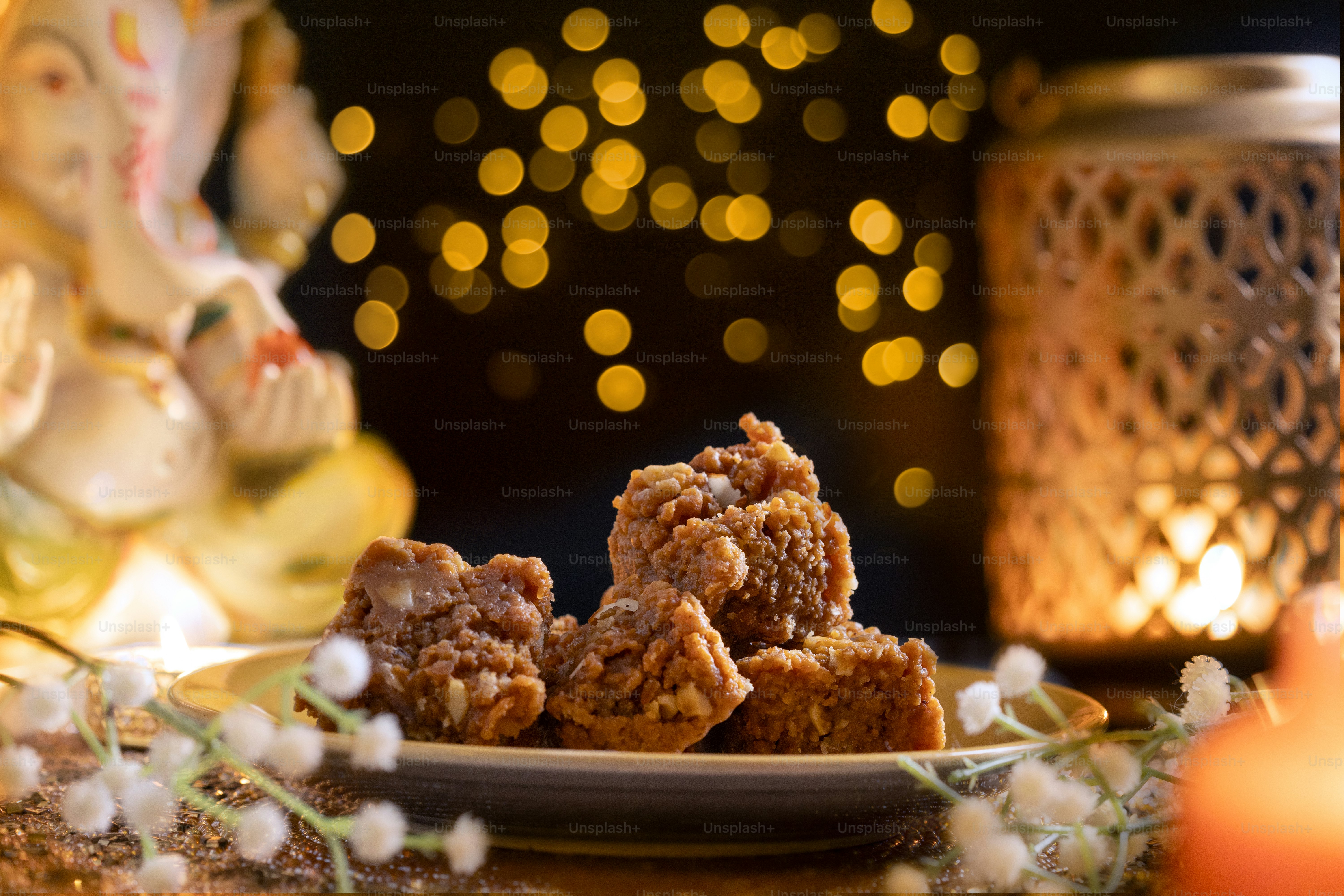 A plate of food sitting on a table next to a candle