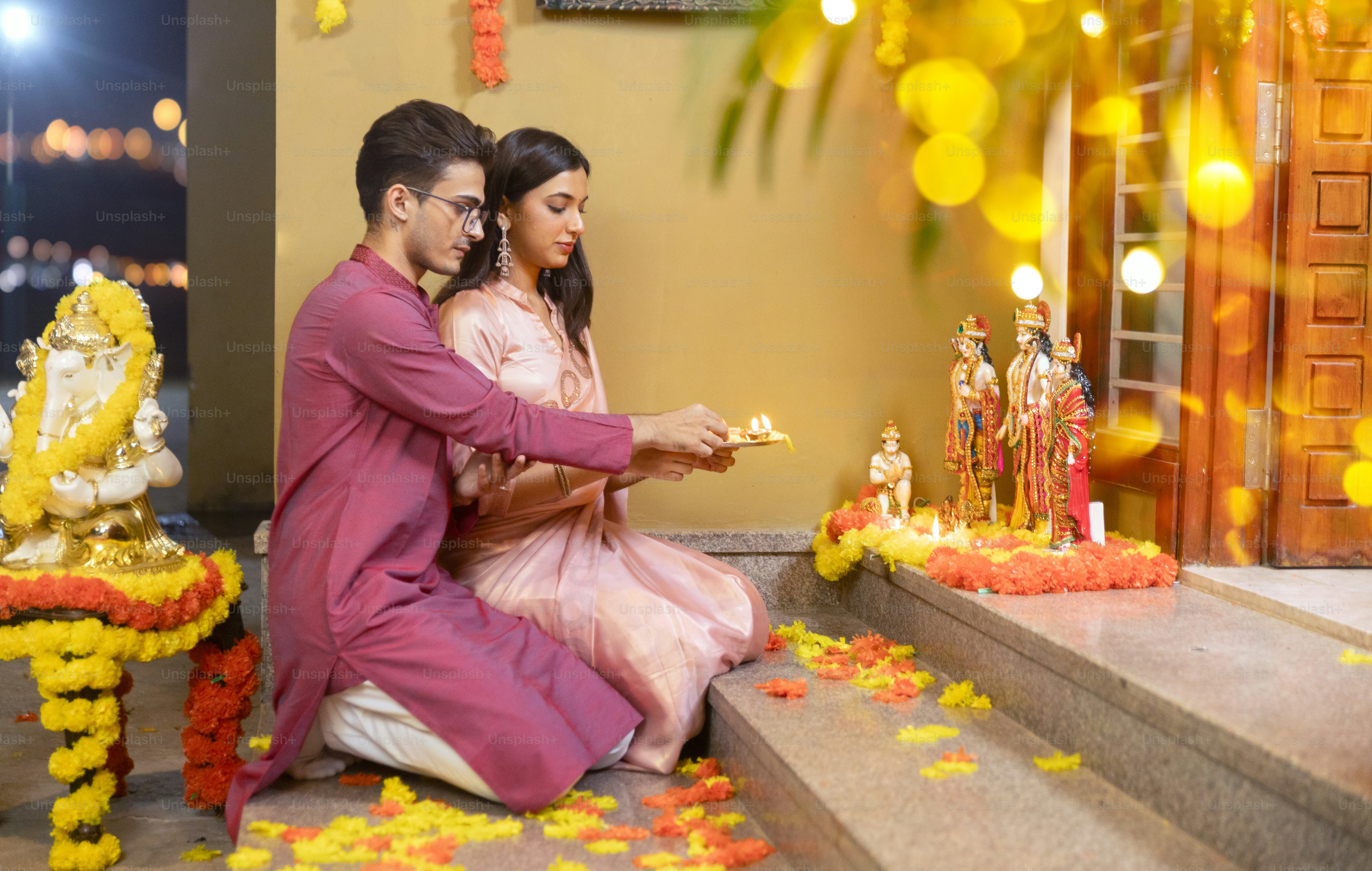 A man and woman sitting on the steps of a temple