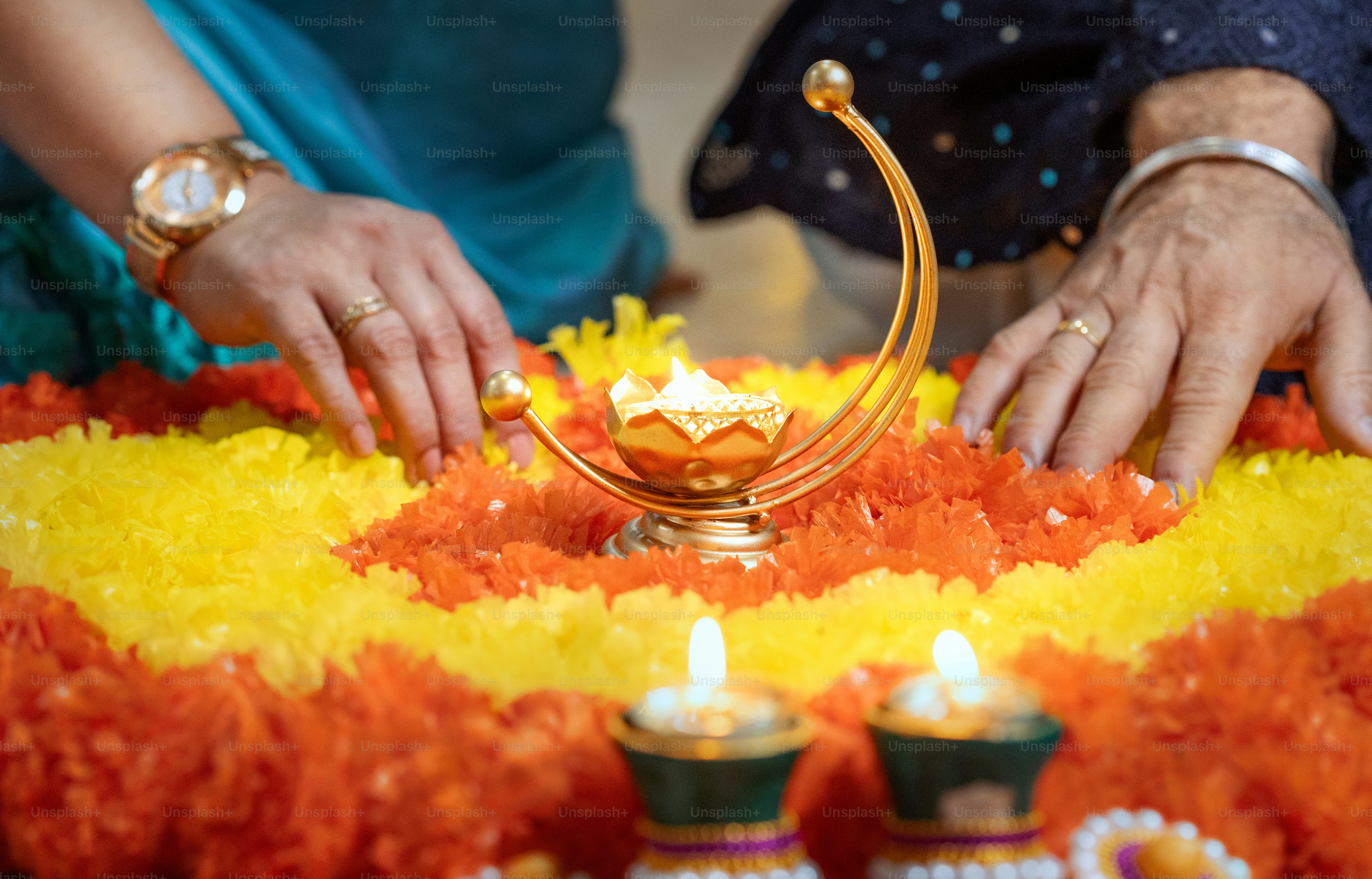 A couple of people that are standing over a cake