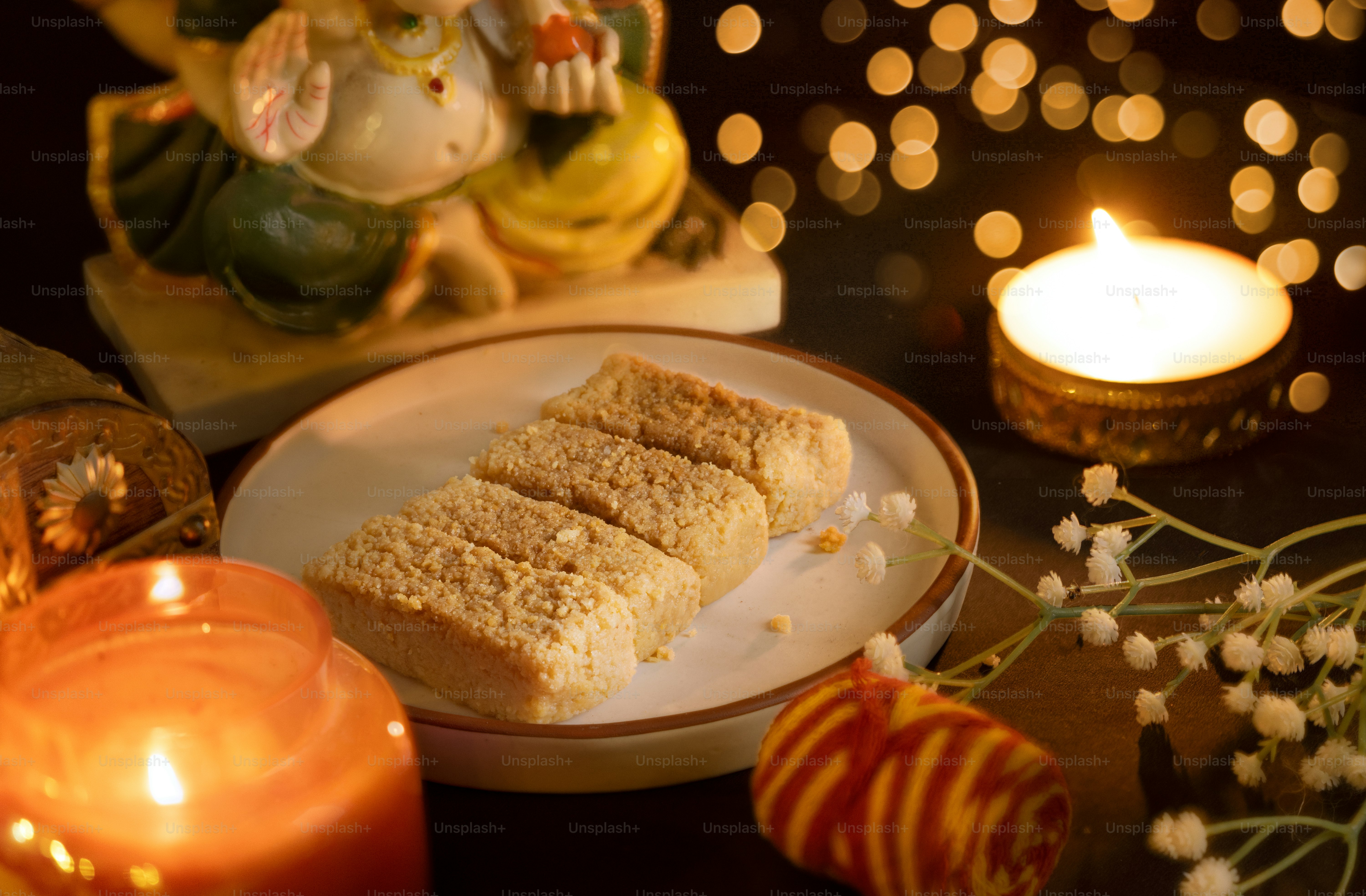 A table topped with a plate of food next to a candle
