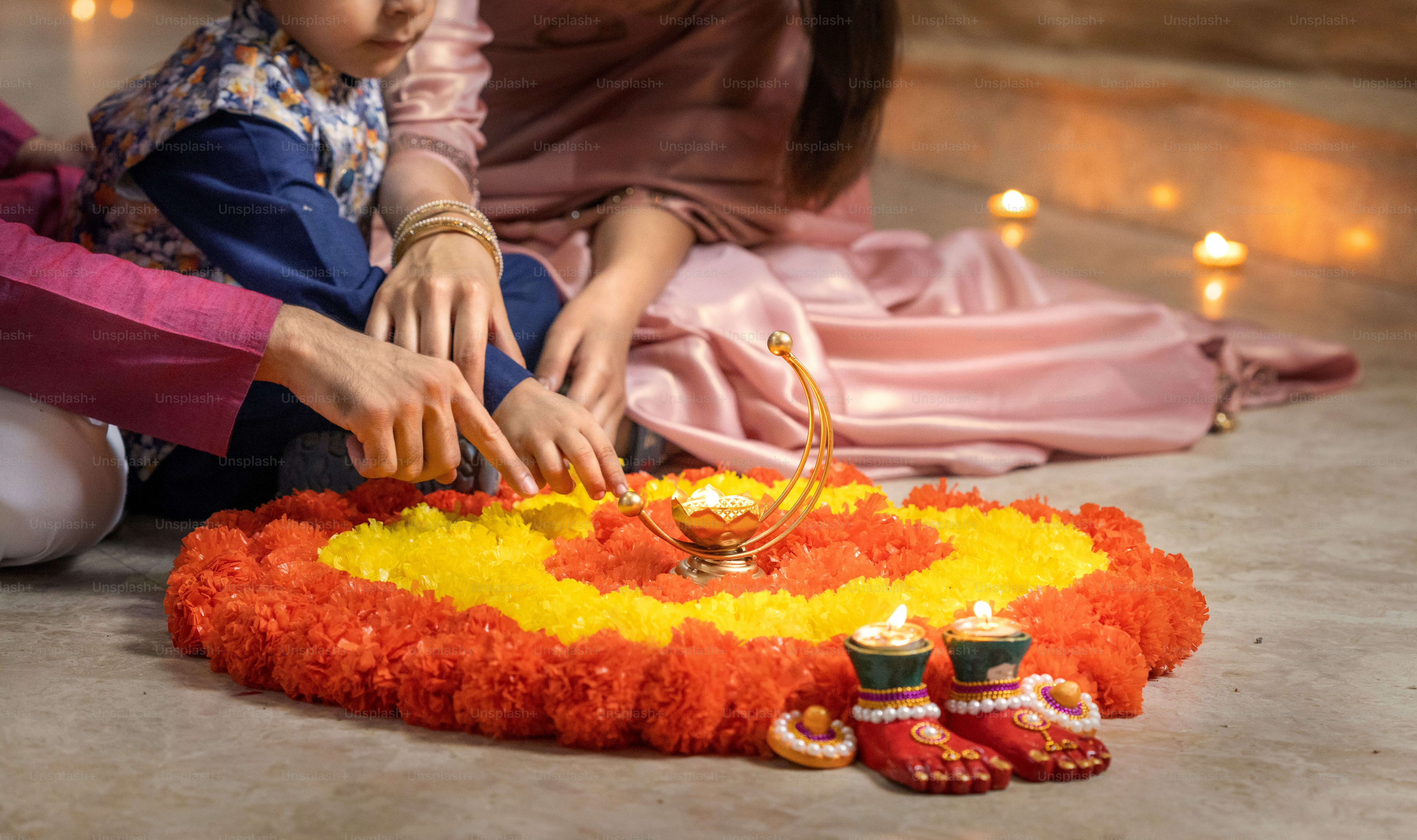 A woman sitting on the ground next to a small child