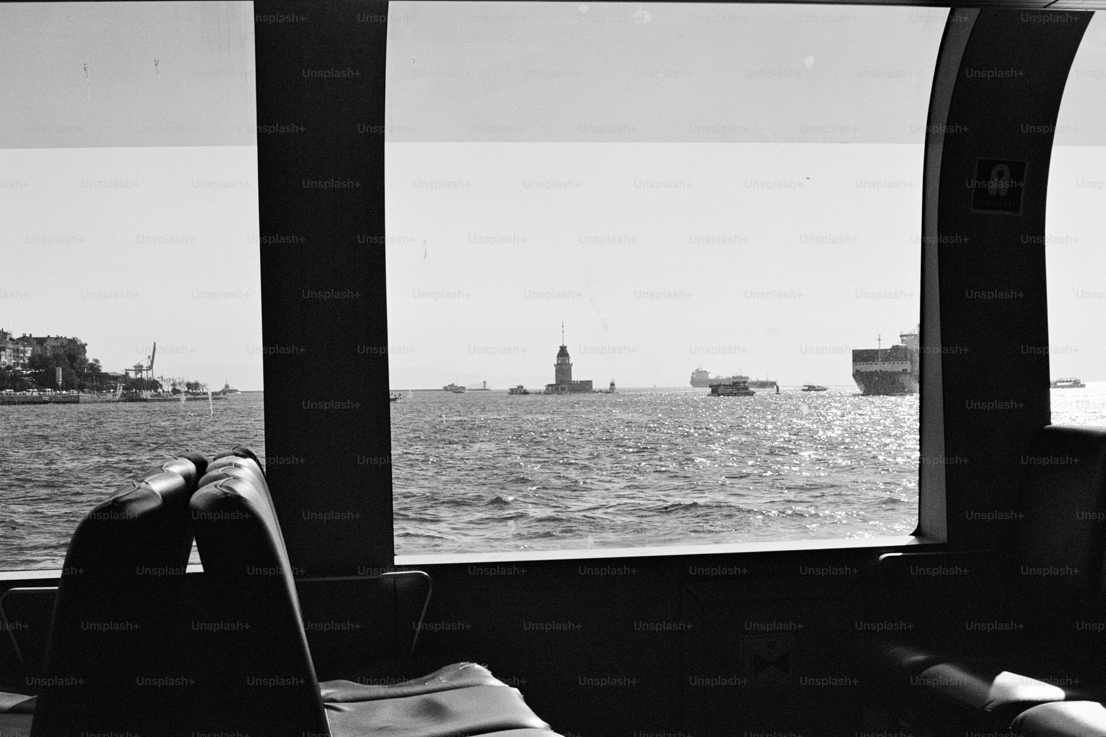 A person sitting on a boat looking out the window