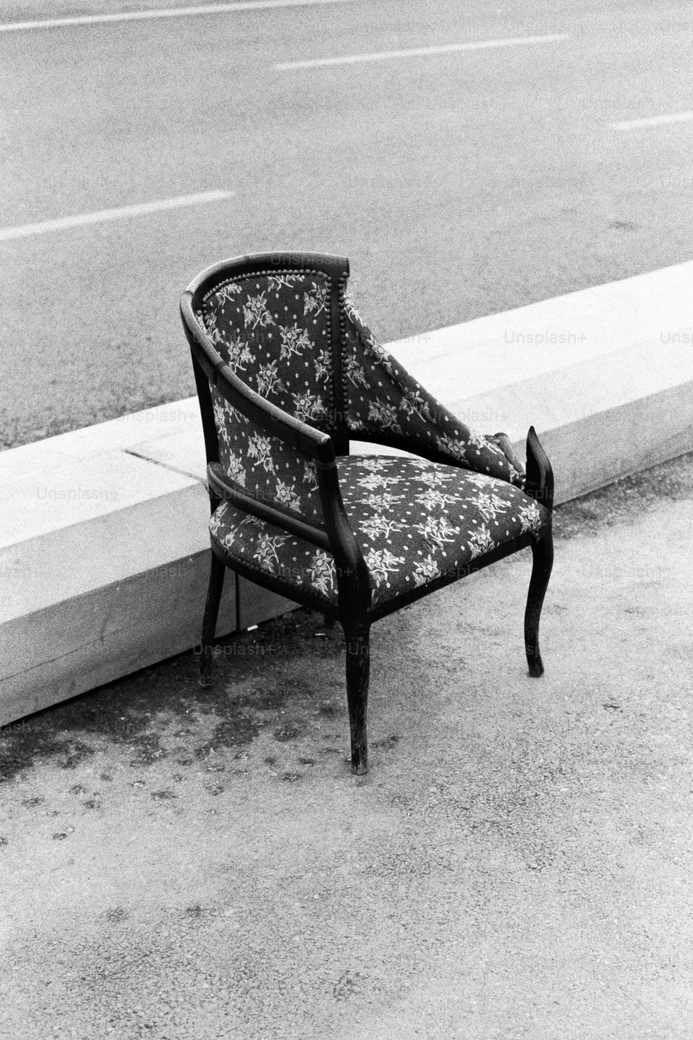 A chair sitting on the side of a road