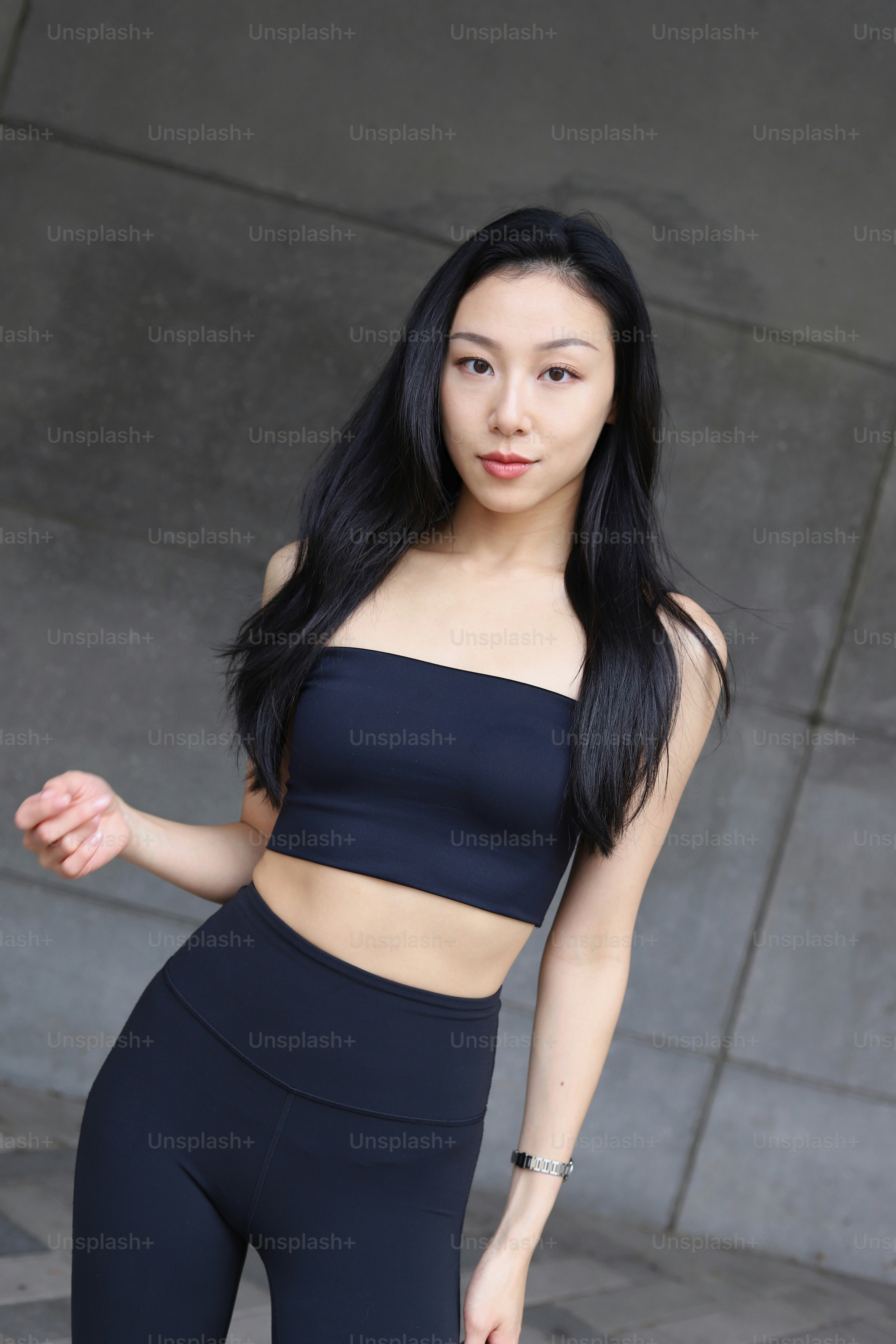 Una mujer con un top negro y leggings