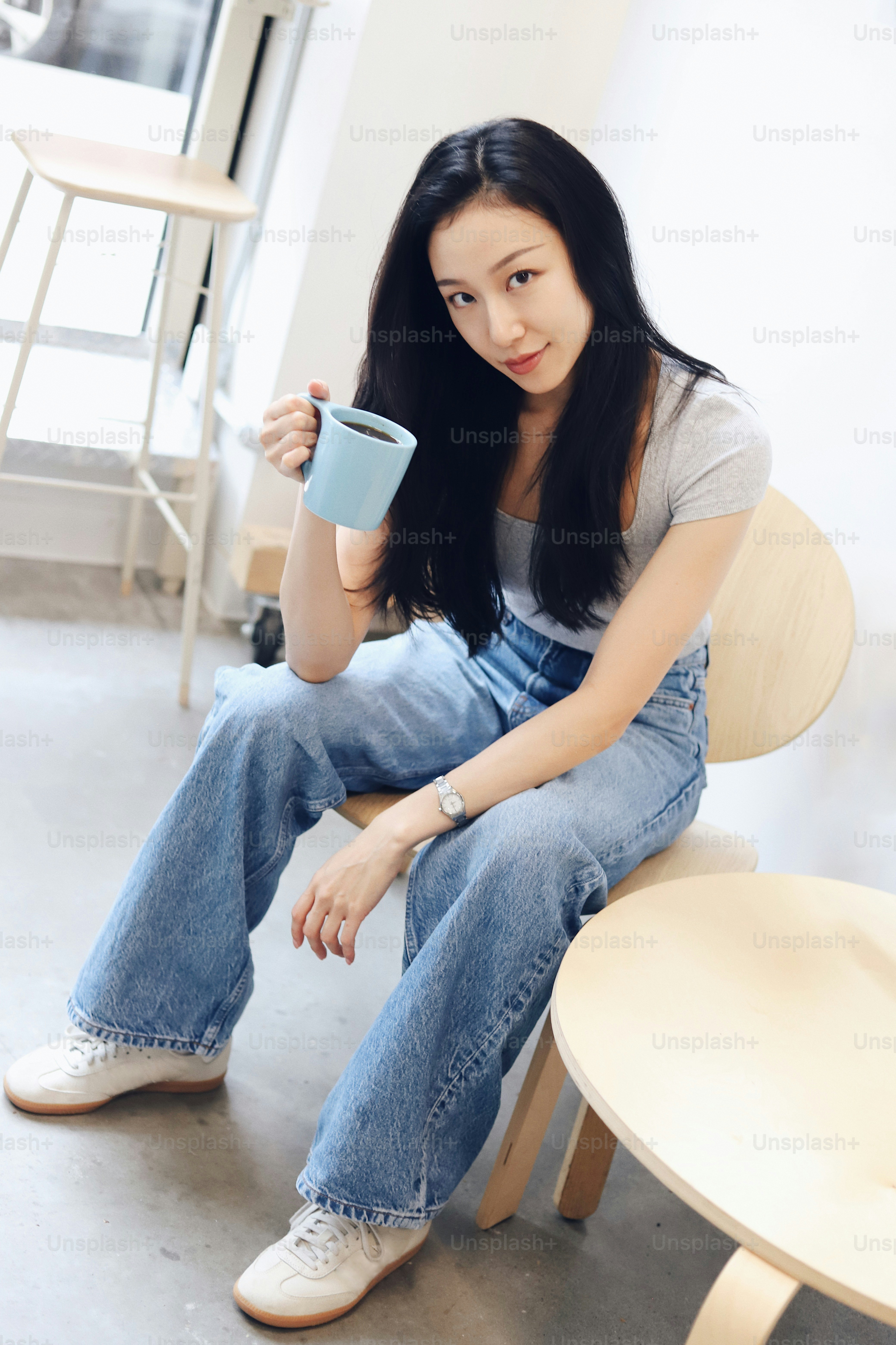 A woman standing in front of a wall photo – Fashion Image on Unsplash