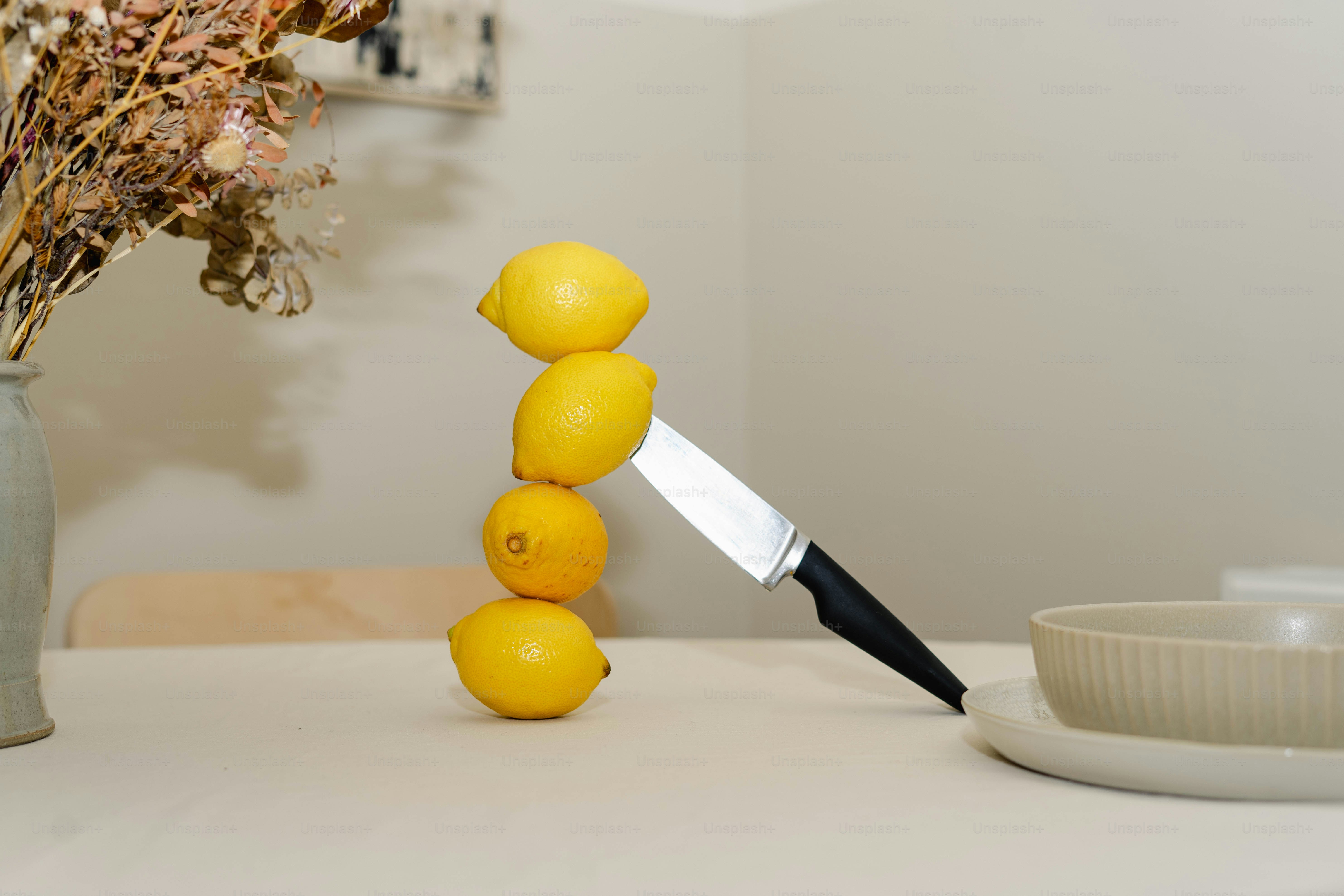 A vase of flowers and a knife on a table