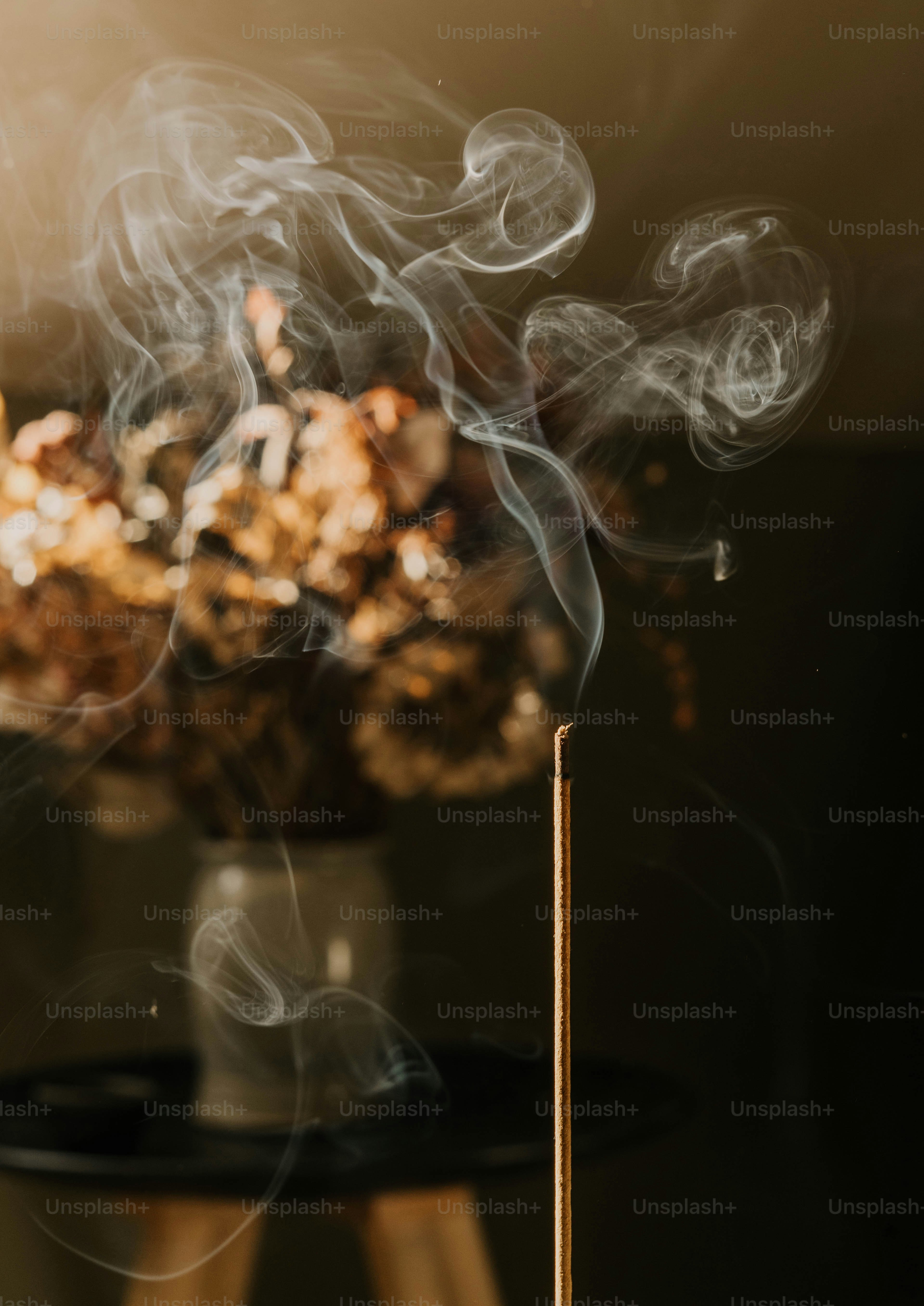 A close up of smoke coming out of a match stick
