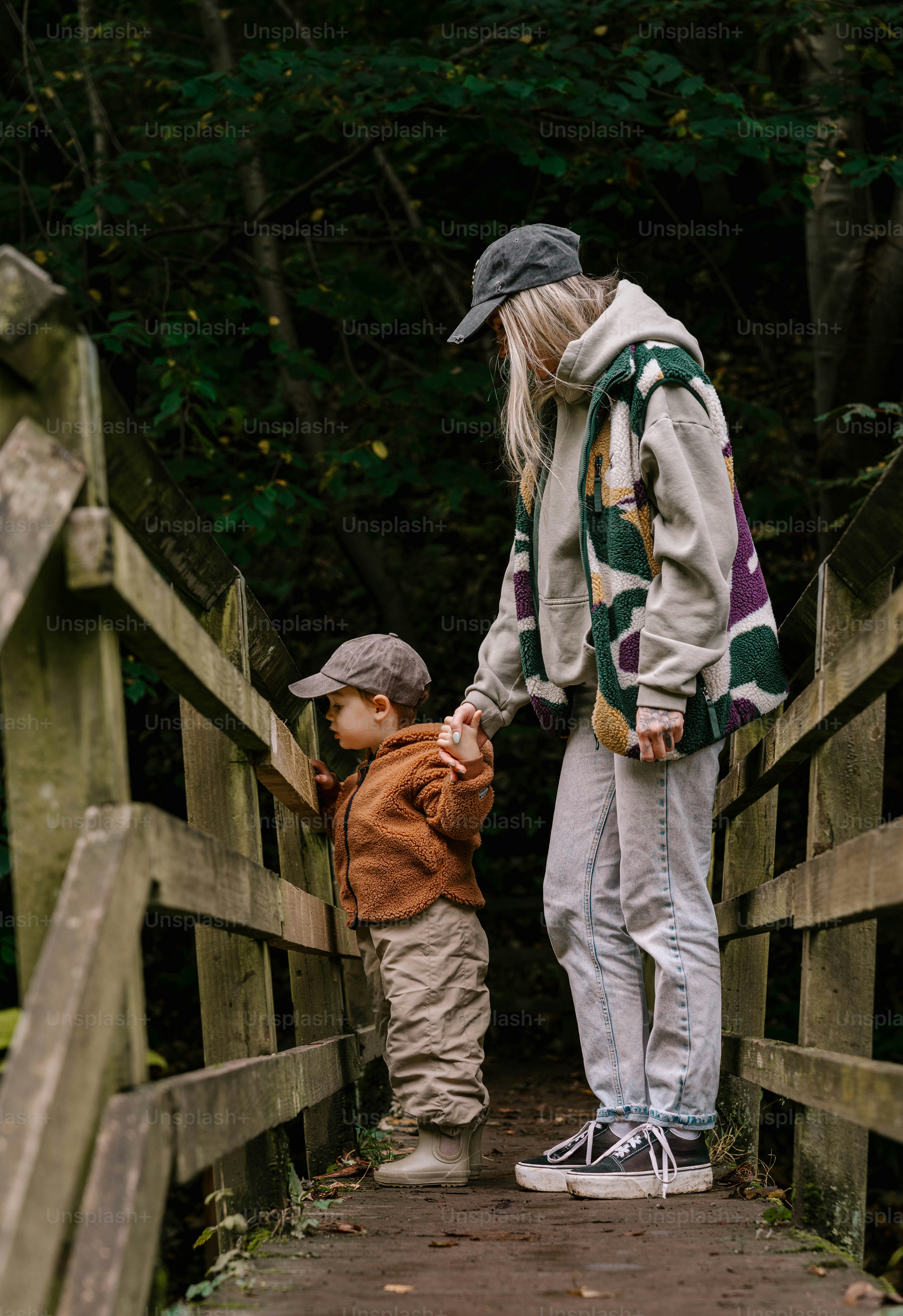 A woman and a child walking across a bridge