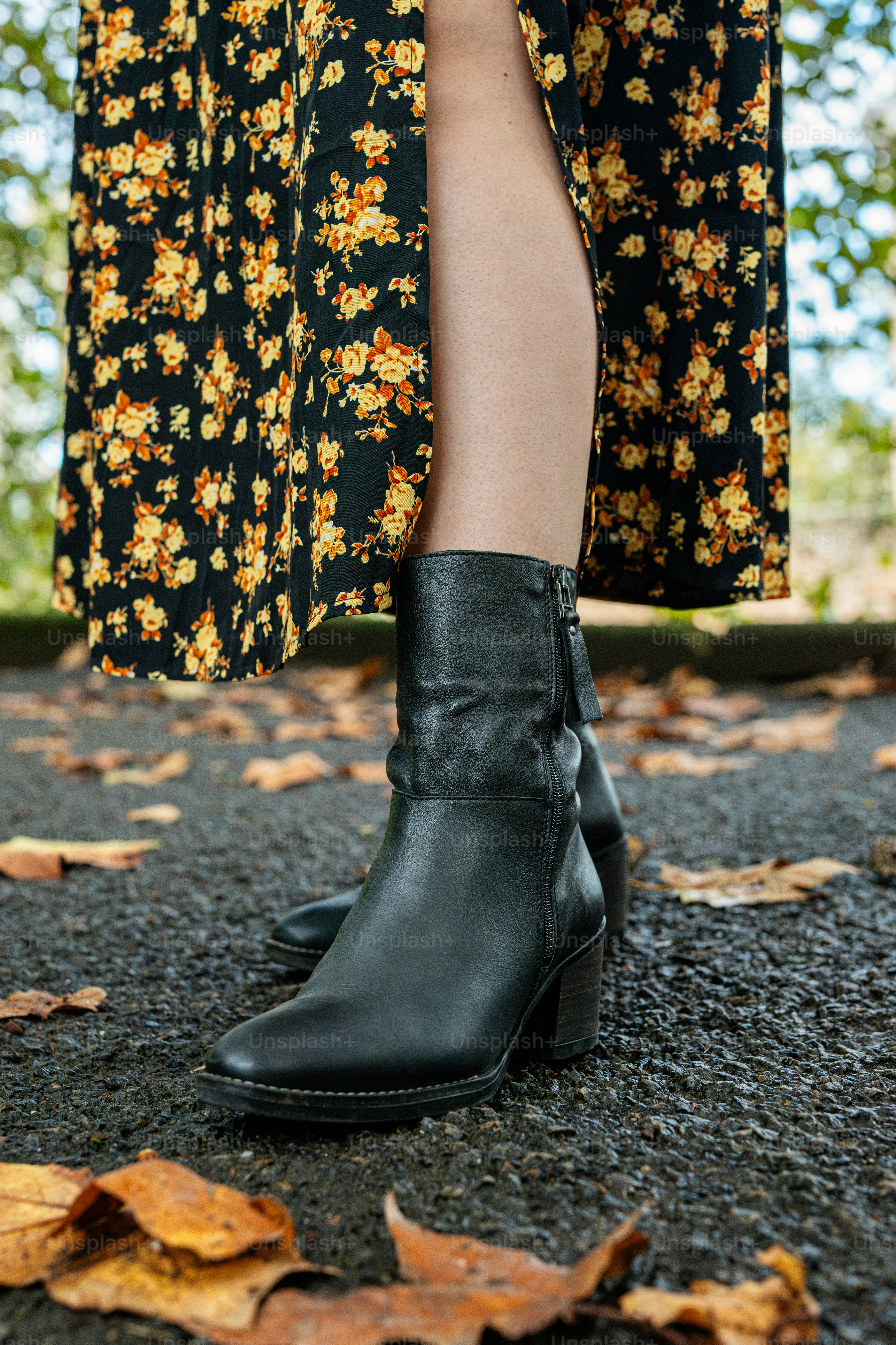 A woman in a floral dress and black boots photo – Fashion Image on Unsplash