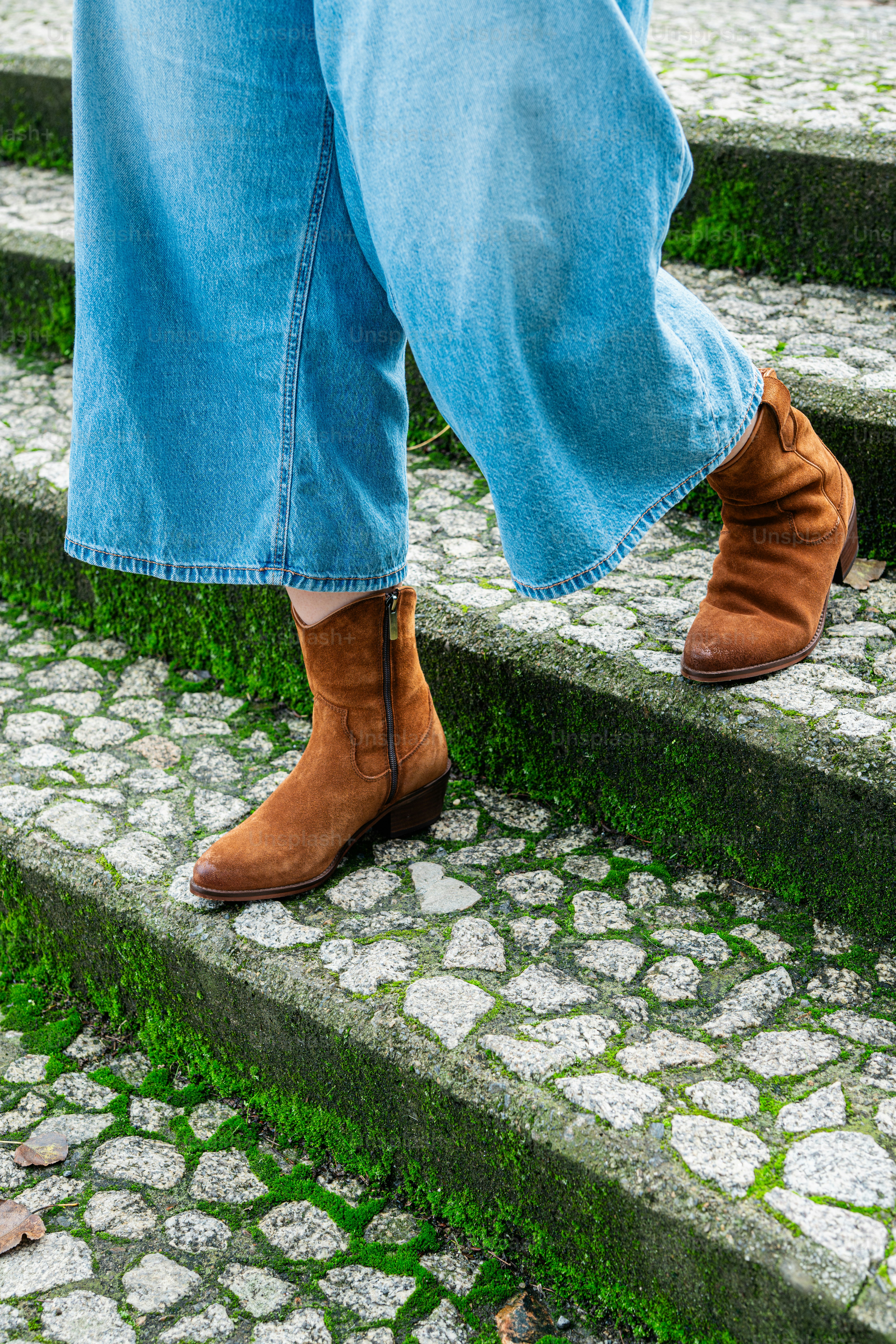 A person standing on a set of stone steps