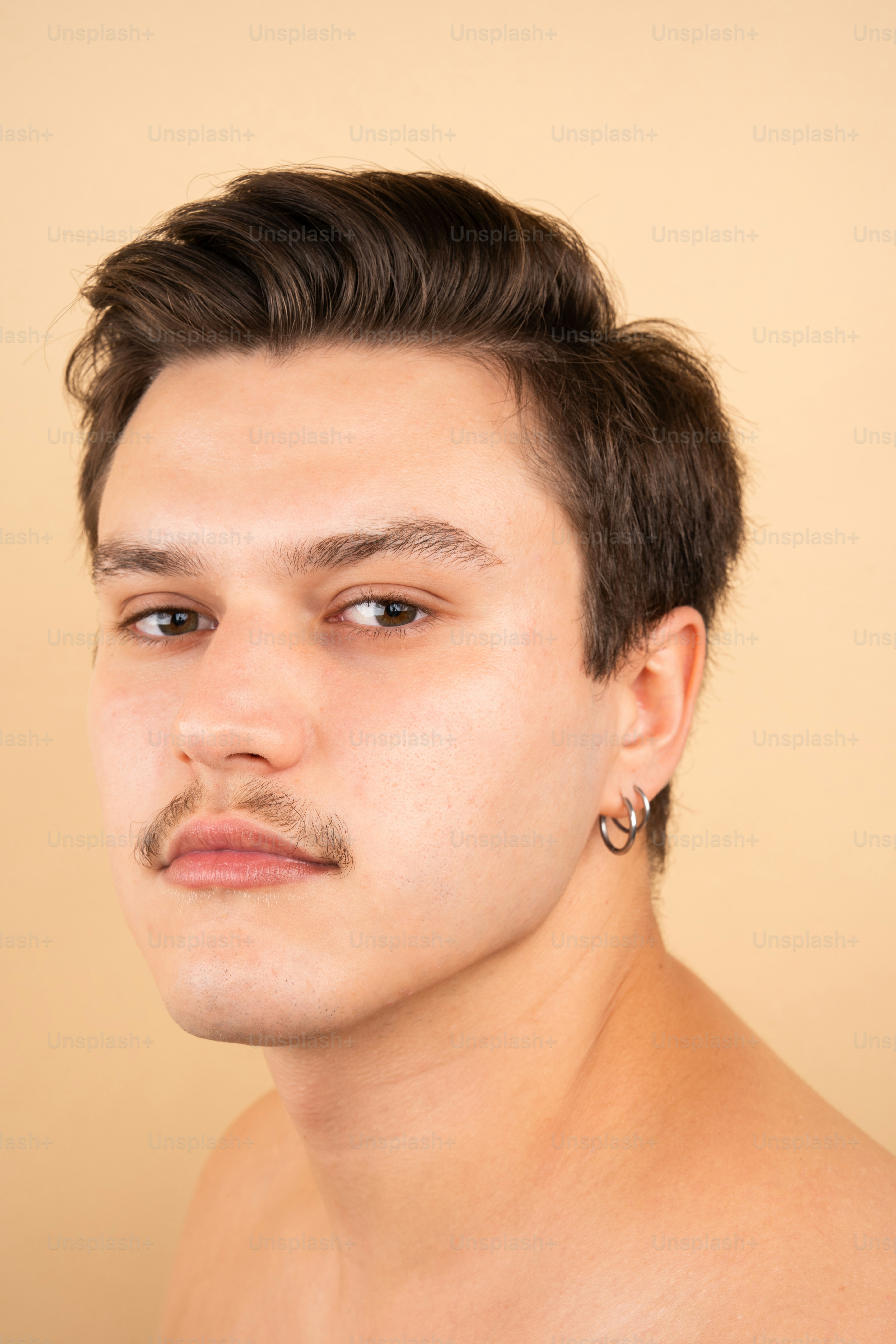 A man with no shirt on posing for a picture