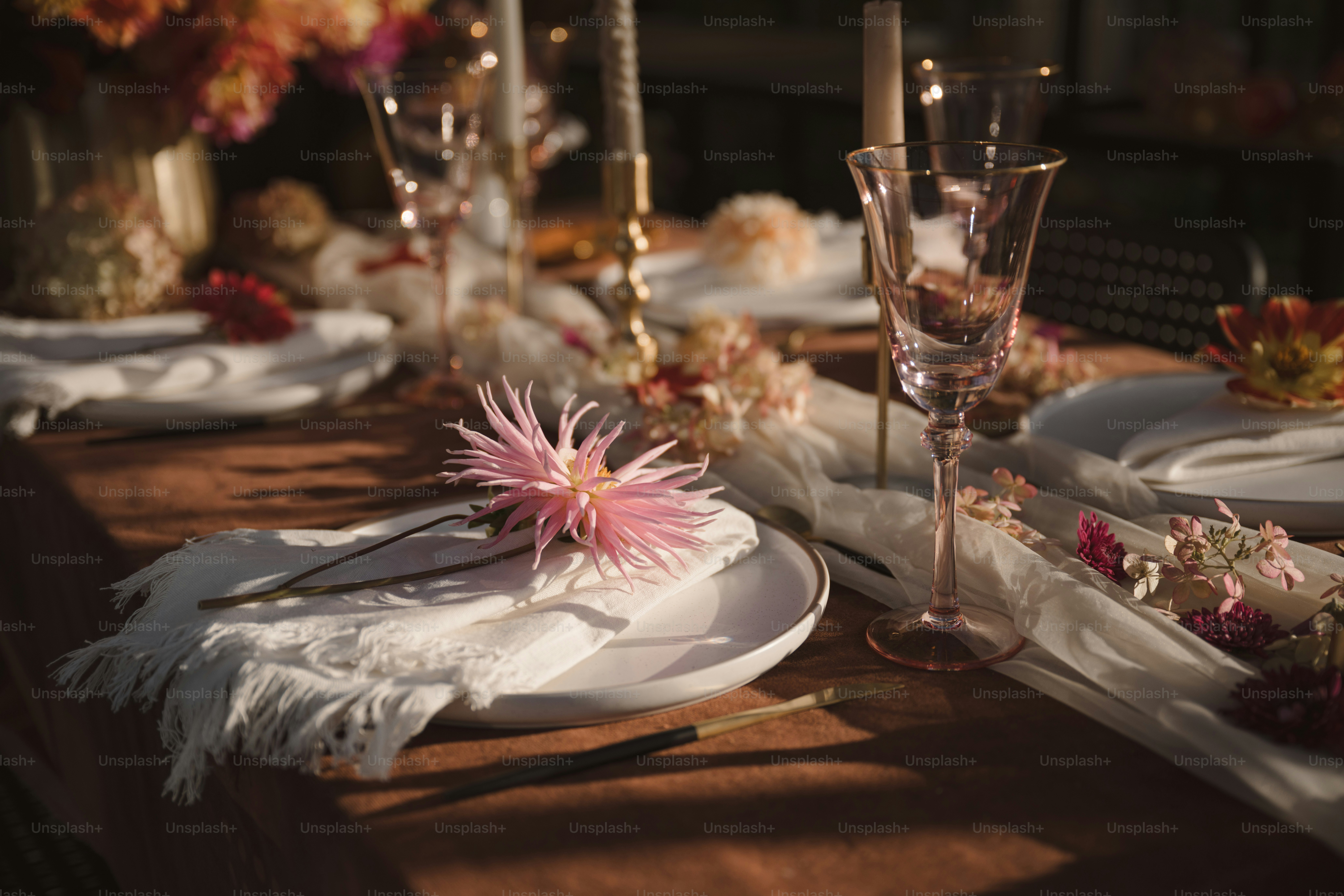 A table set for a formal dinner with flowers and candles