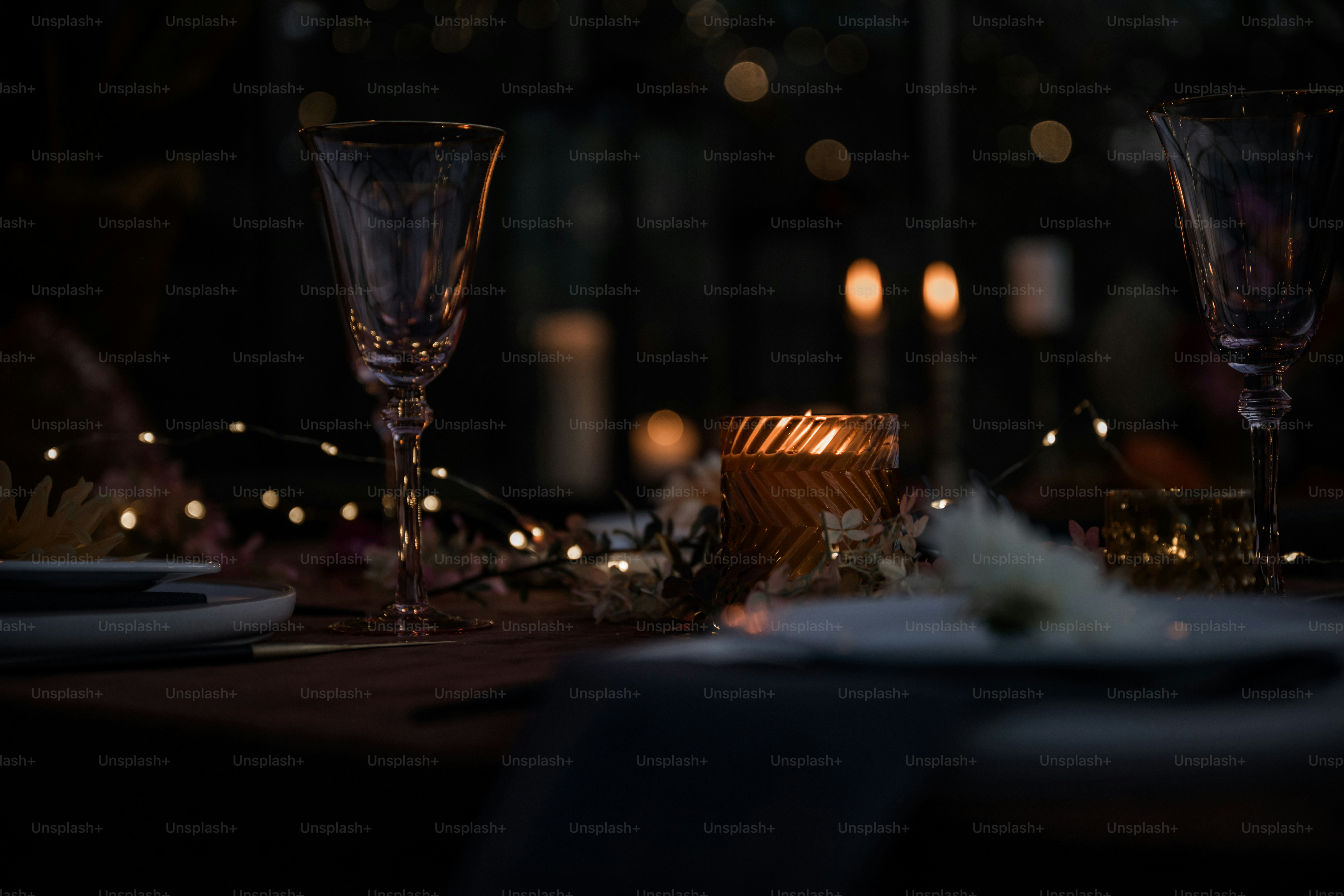 A table with candles and plates on it