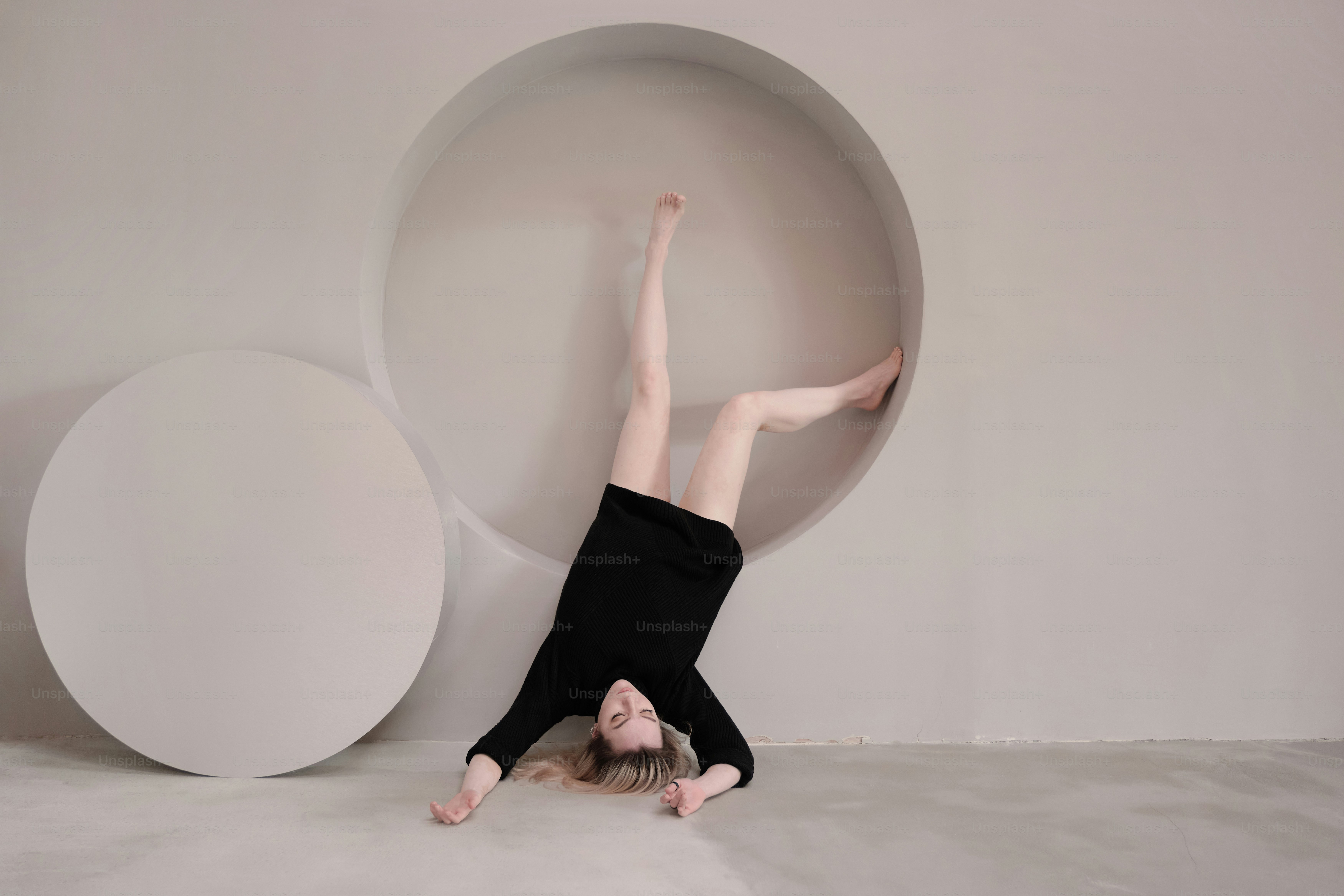 A person is upside down on a bed