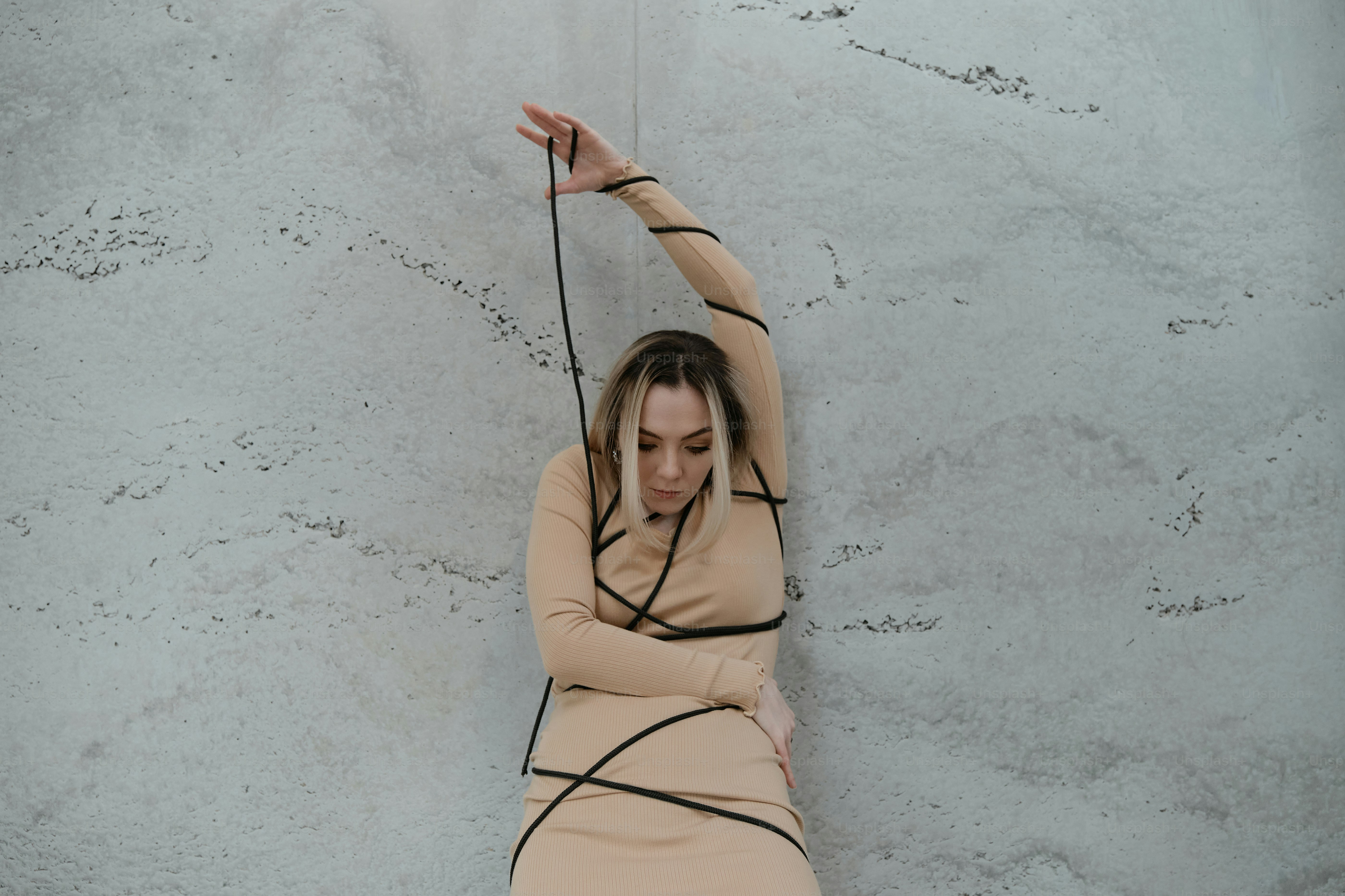 A woman in a dress is holding a string