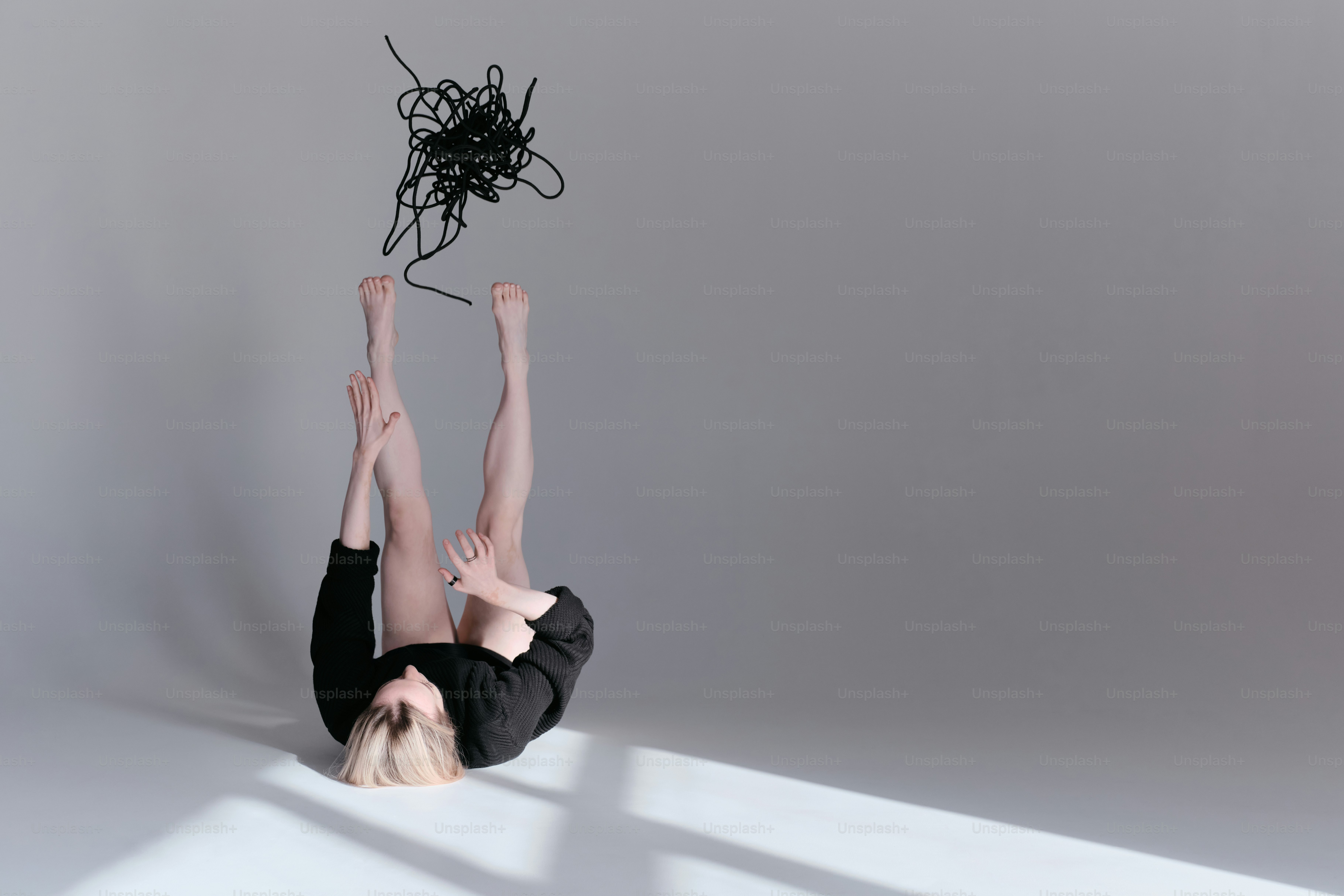 A woman is doing a handstand on the floor