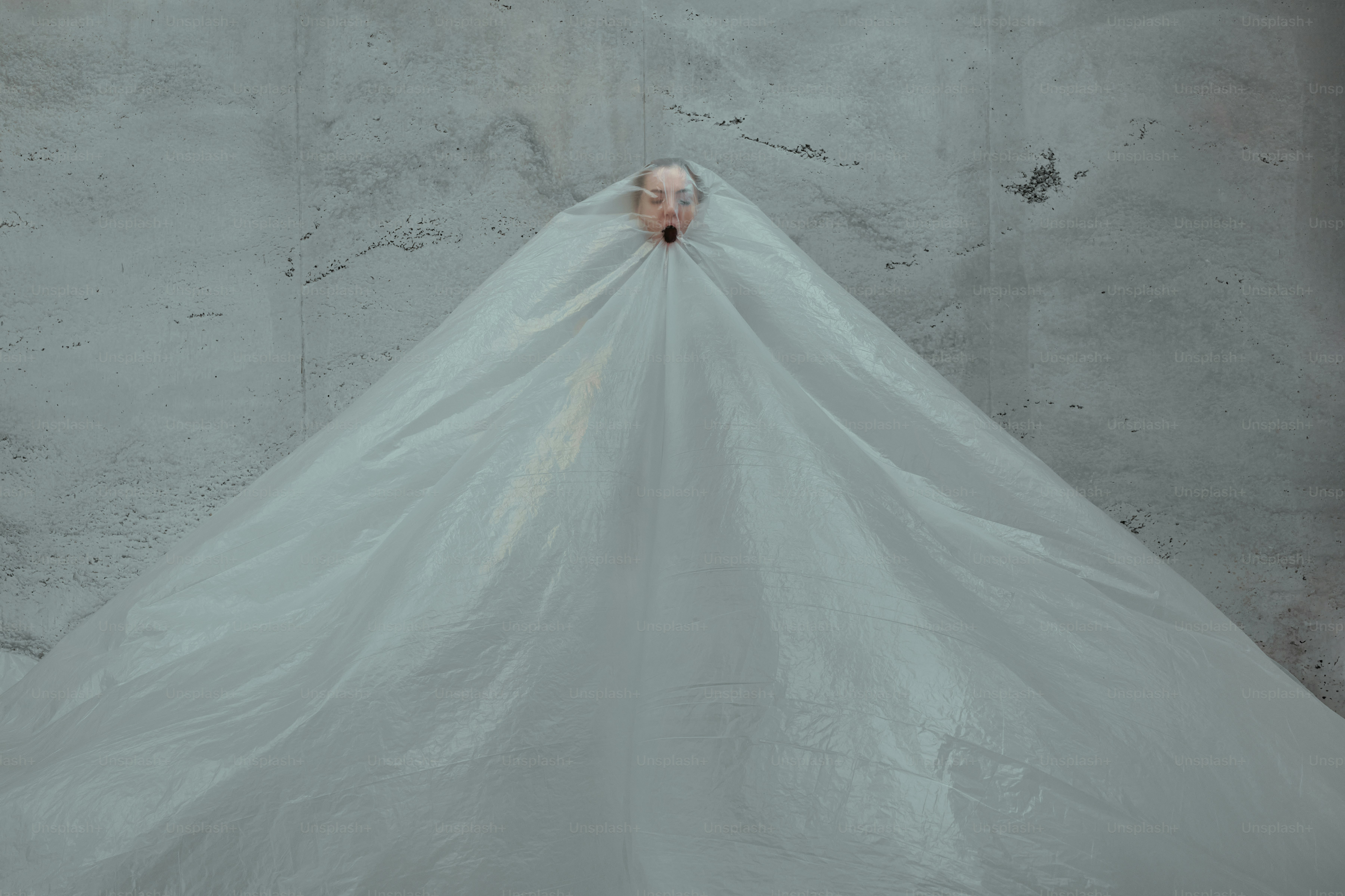 A woman in a white dress standing in a room