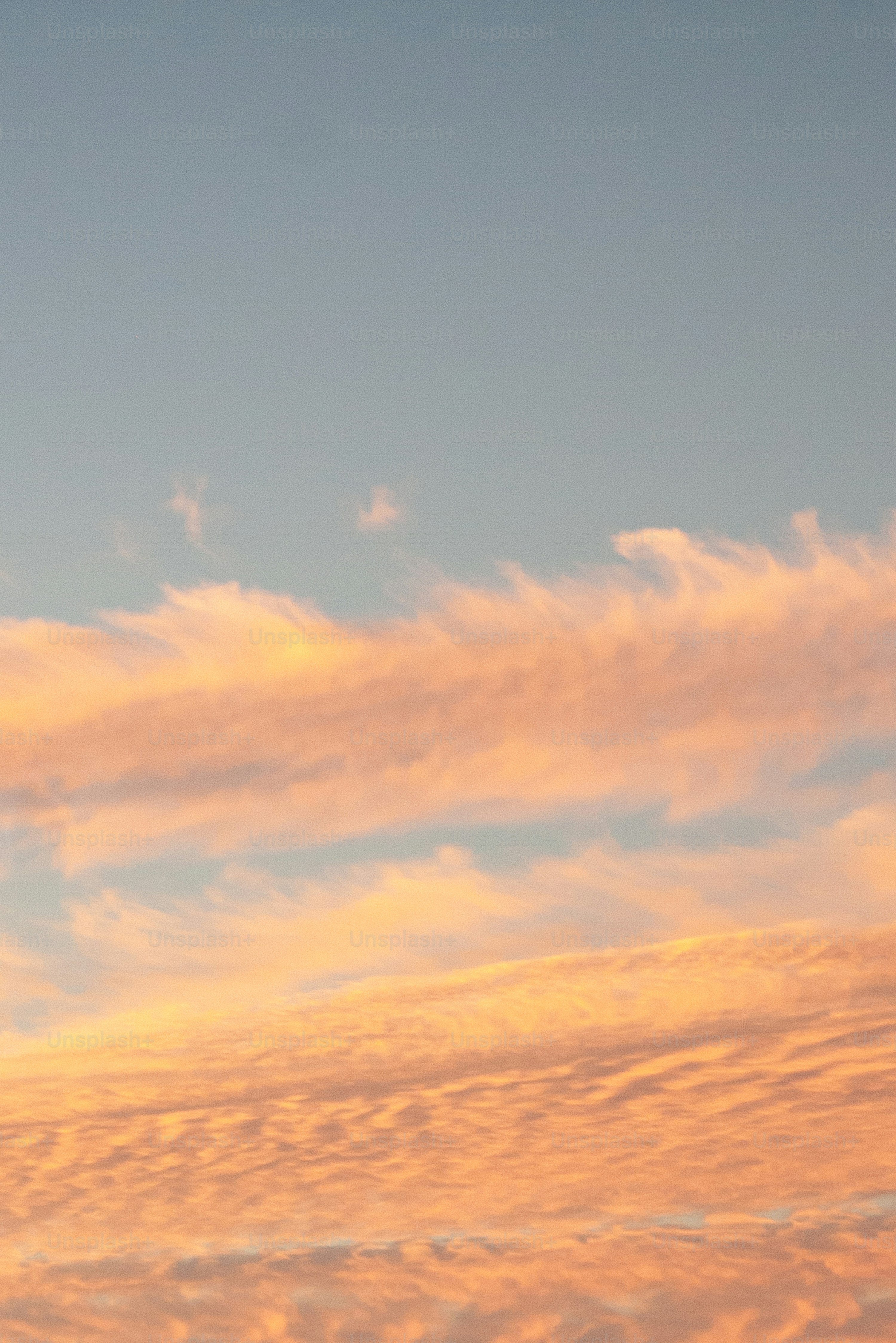 A plane flying in the sky at sunset