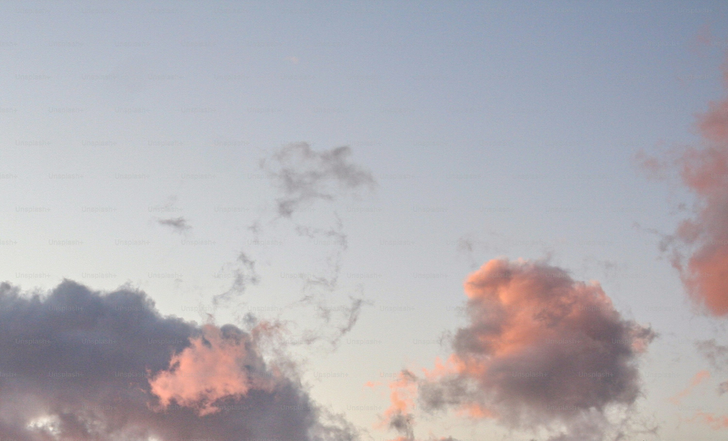A plane flying in the sky with a lot of clouds