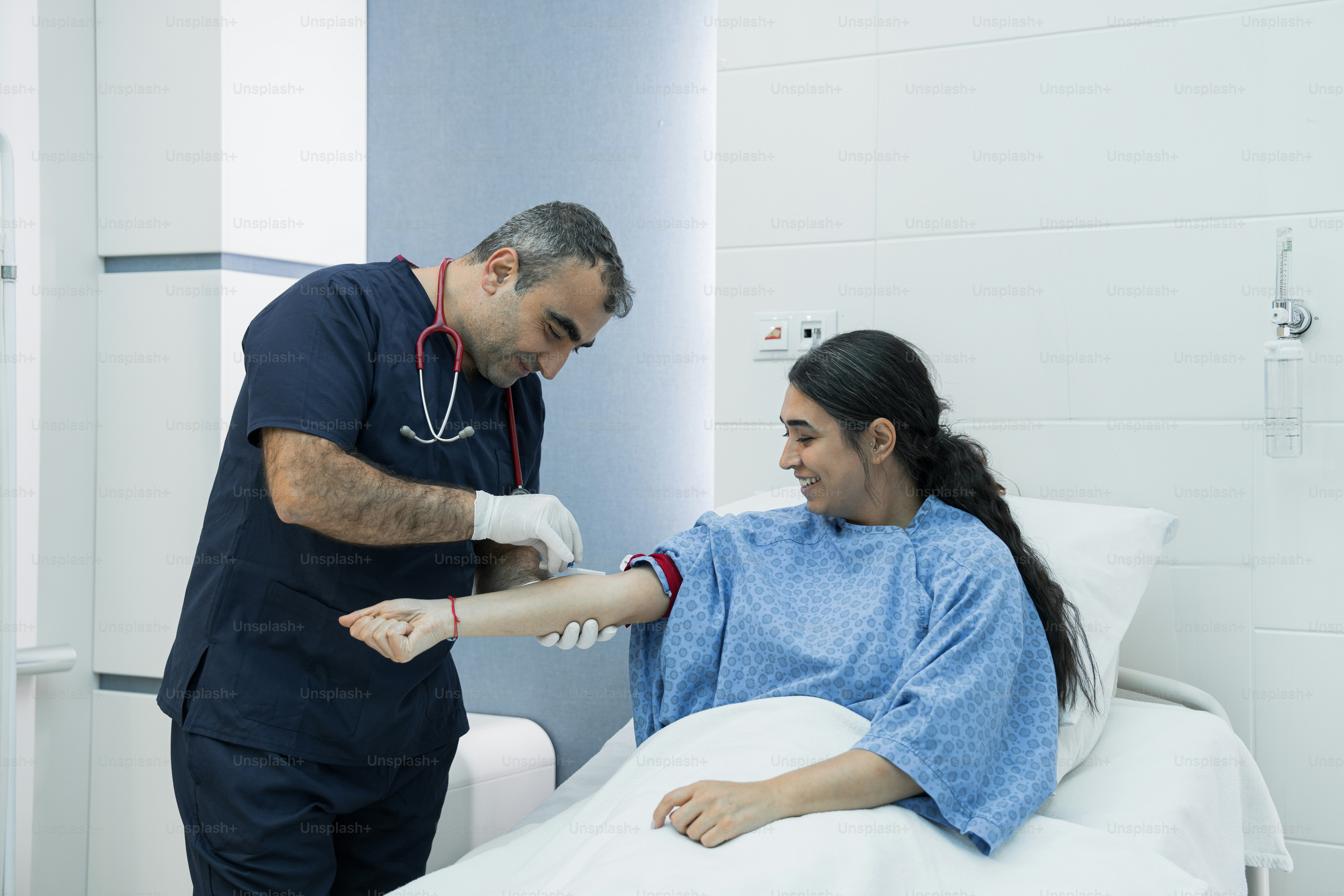 A man standing next to a woman in a hospital bed