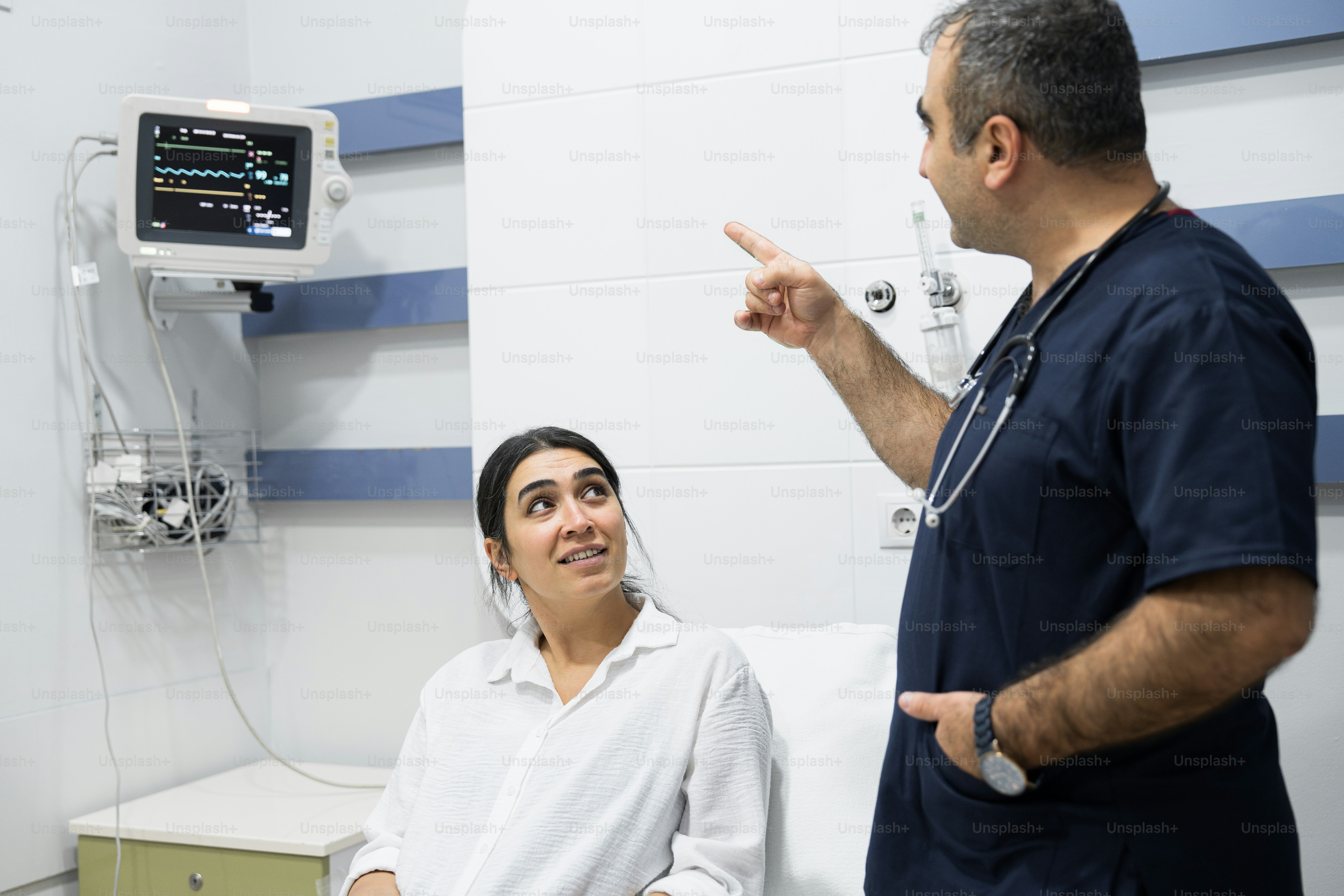A doctor talking to a patient in a hospital room