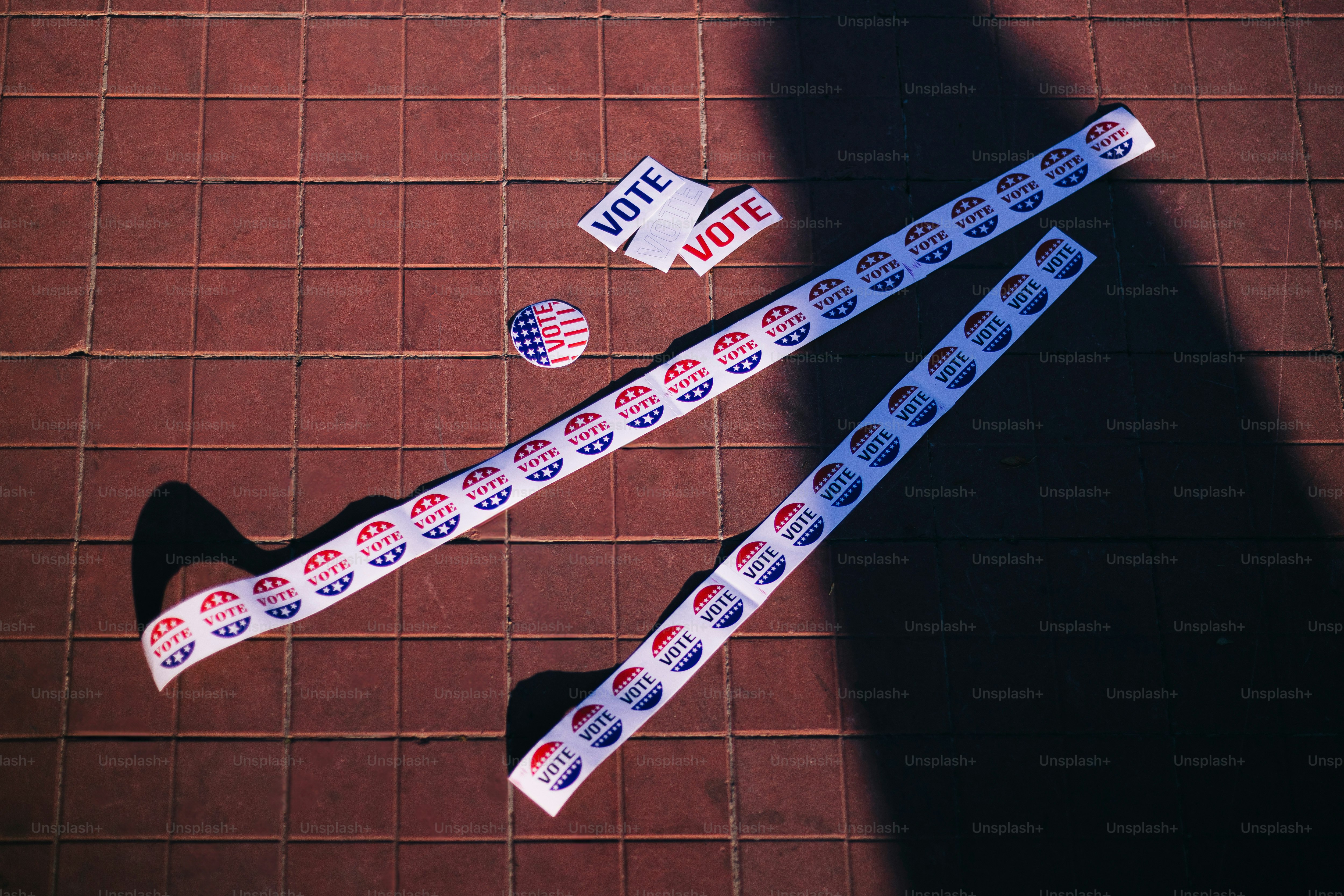 A person standing next to a pair of scissors and tape