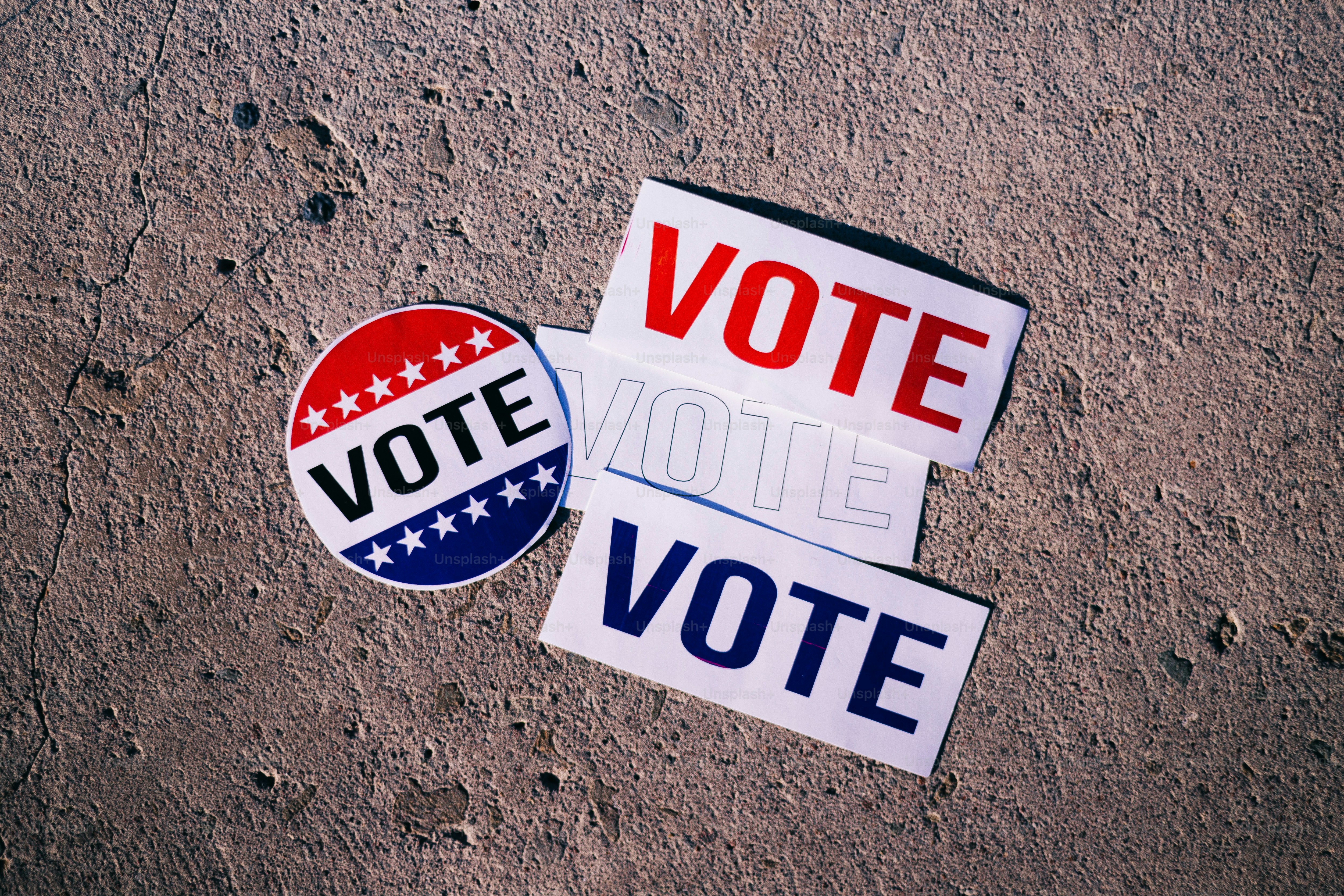 A pair of political stickers sitting on the ground