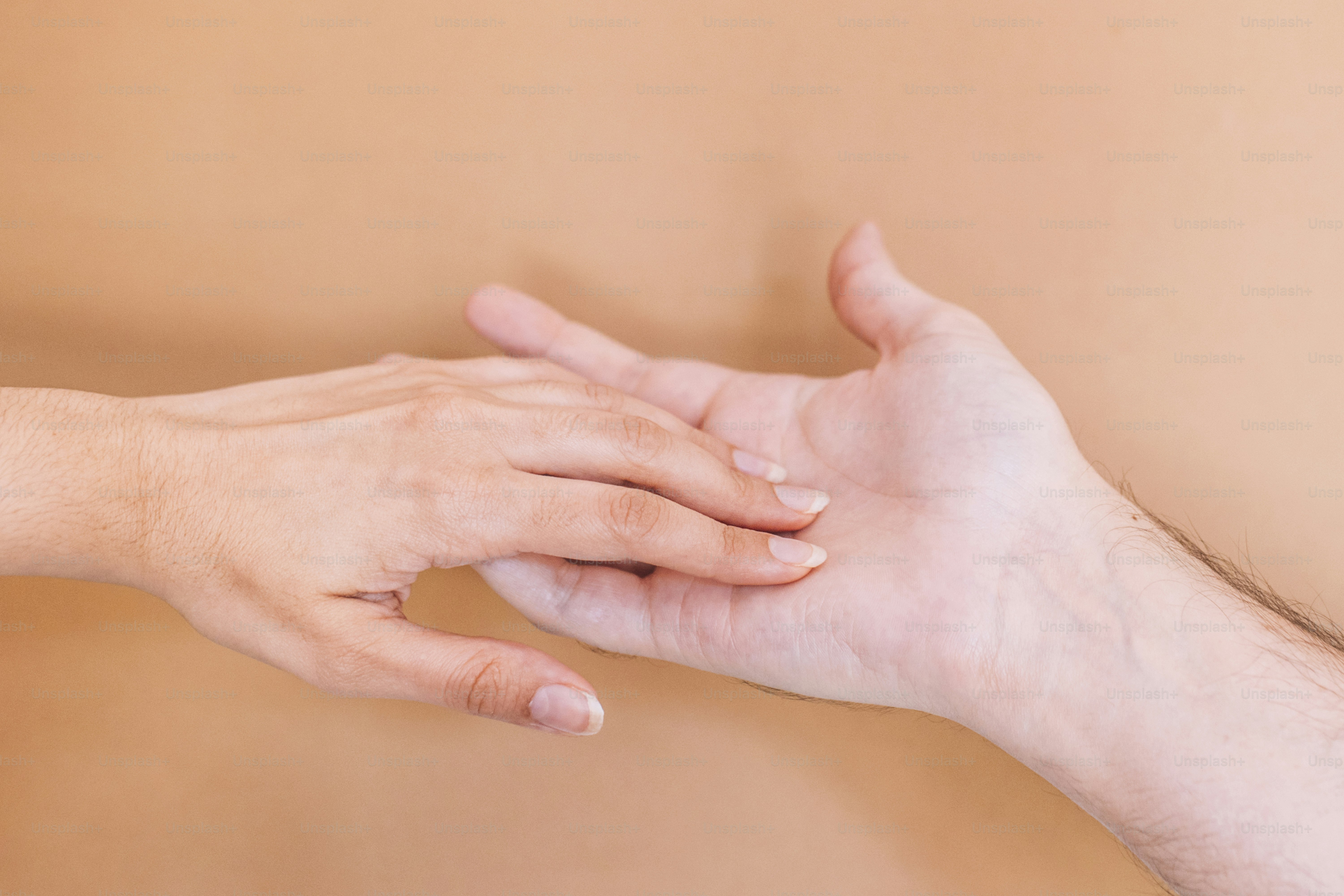 A person holding another person's hand in a room