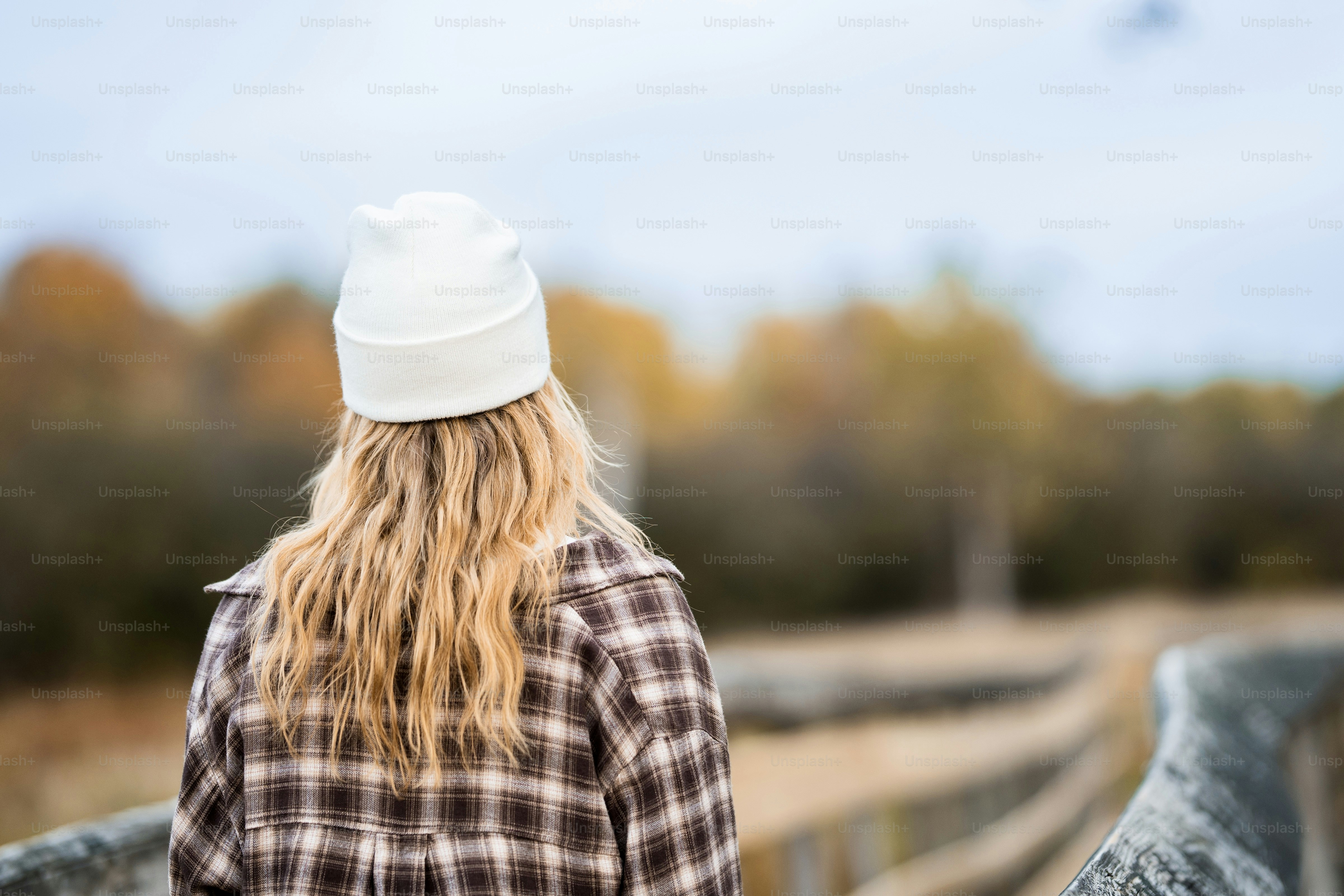 A woman with long hair wearing a white hat
