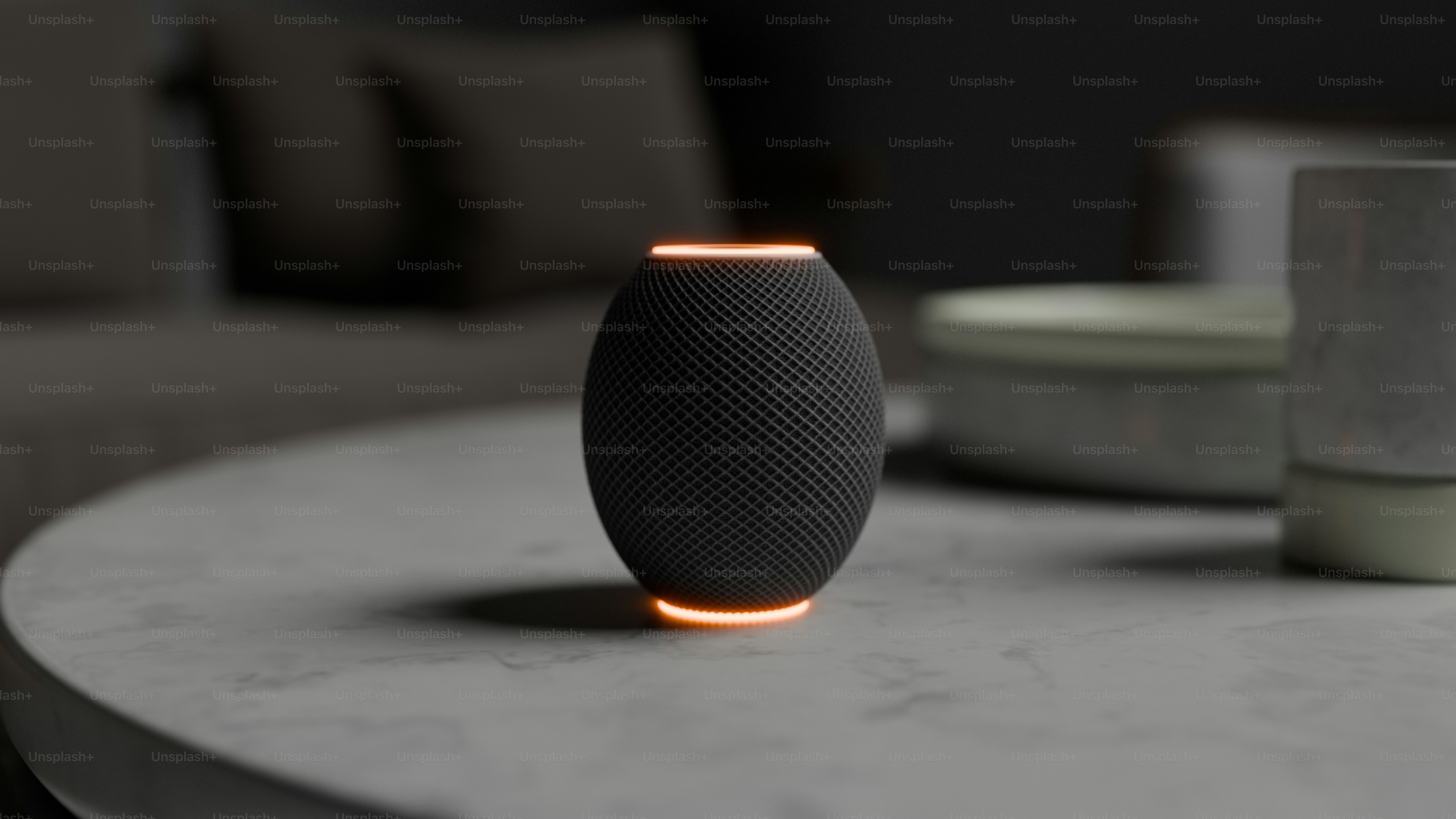 A table with a black speaker on top of it