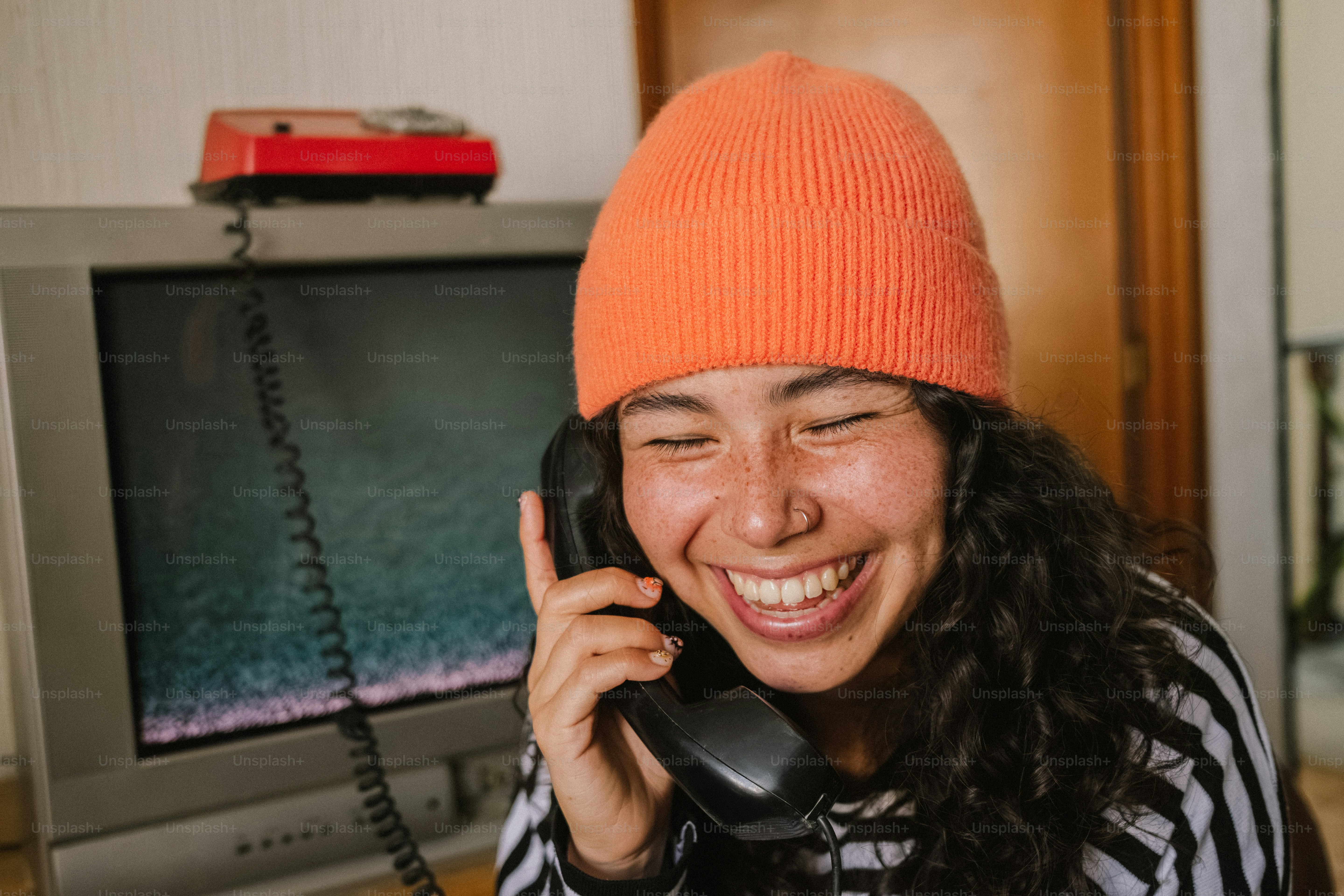 A smiling woman talking on a cell phone