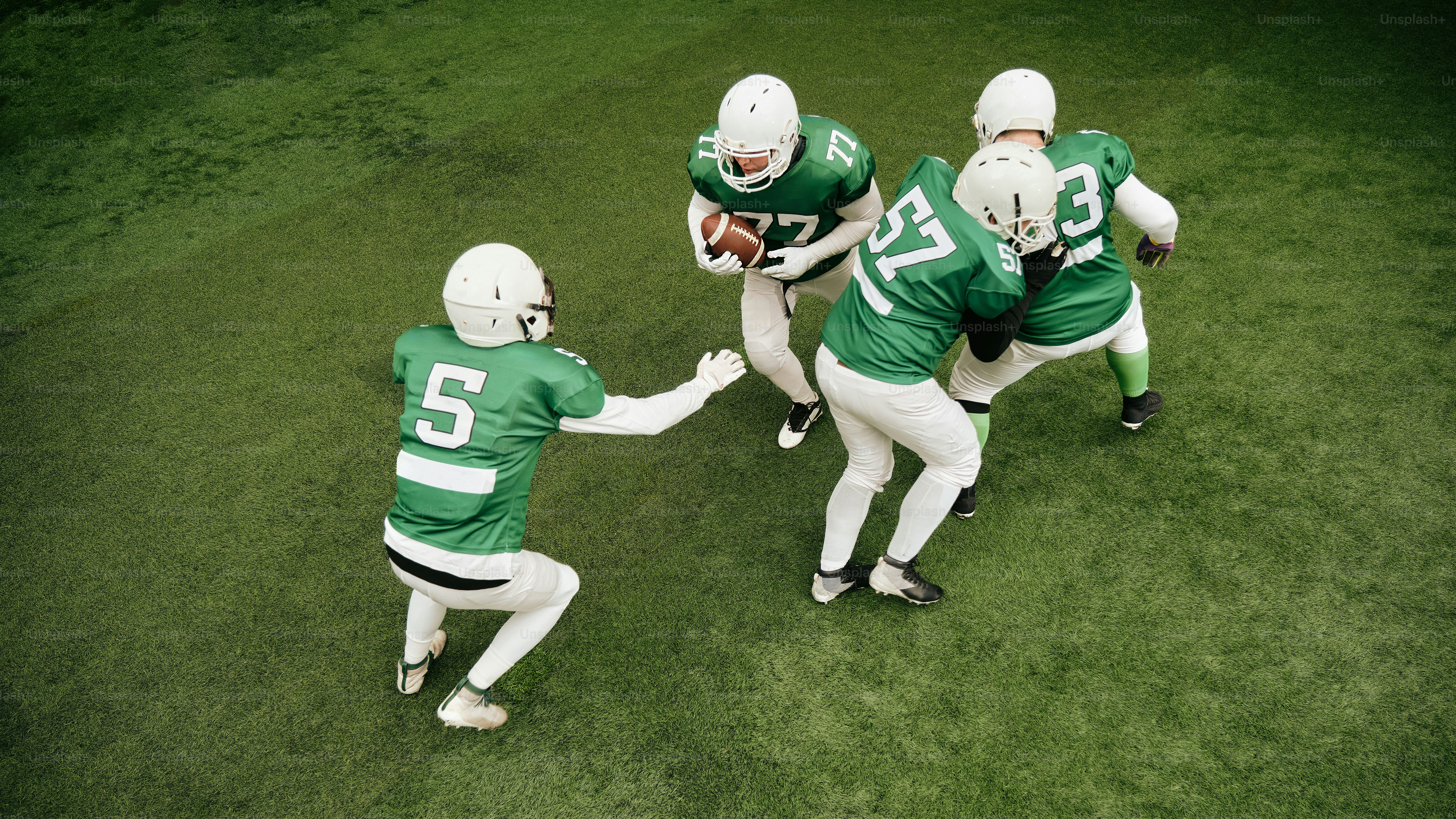 A group of young men playing a game of football photo – Team Image on ...
