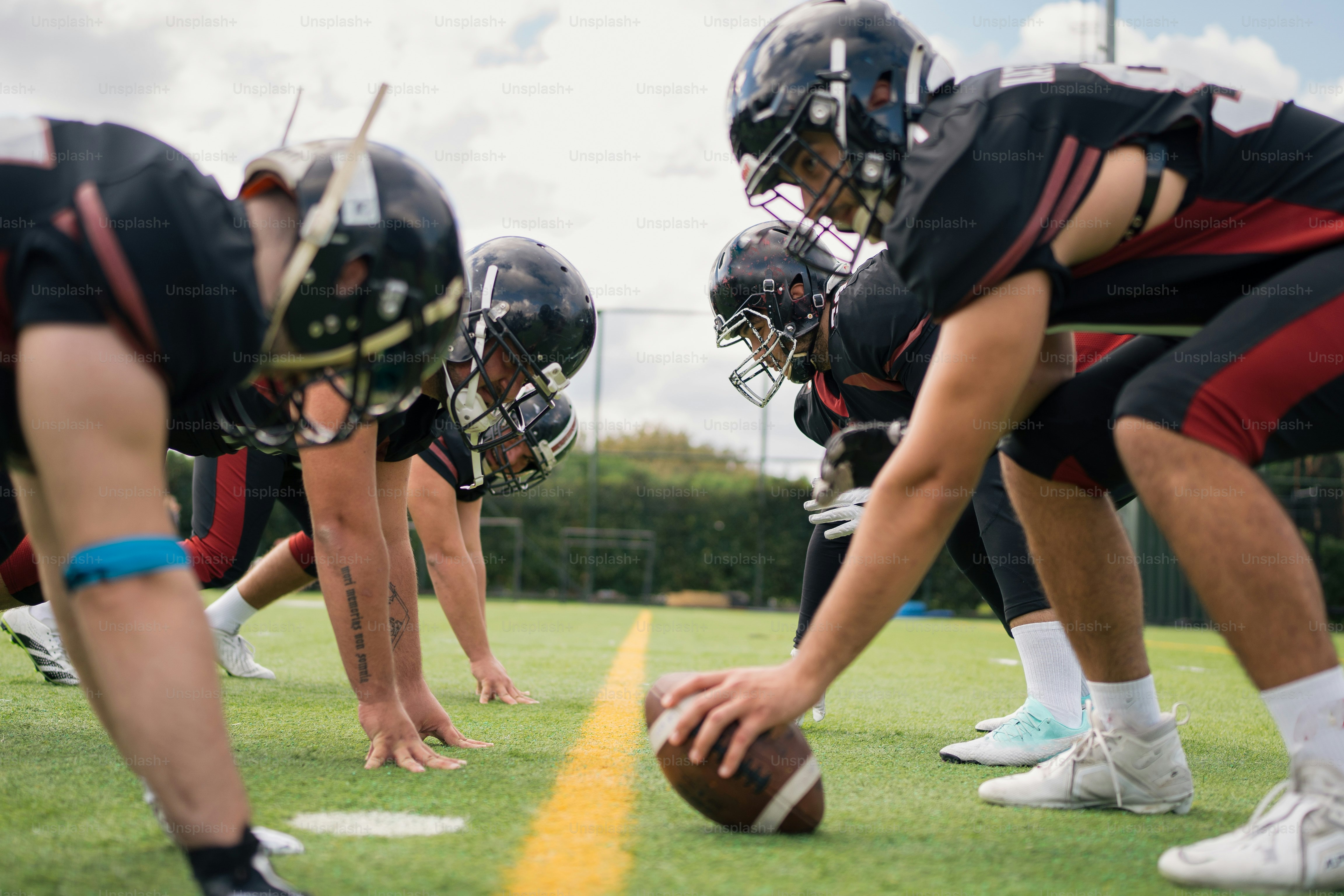 A group of football players standing on top of a field