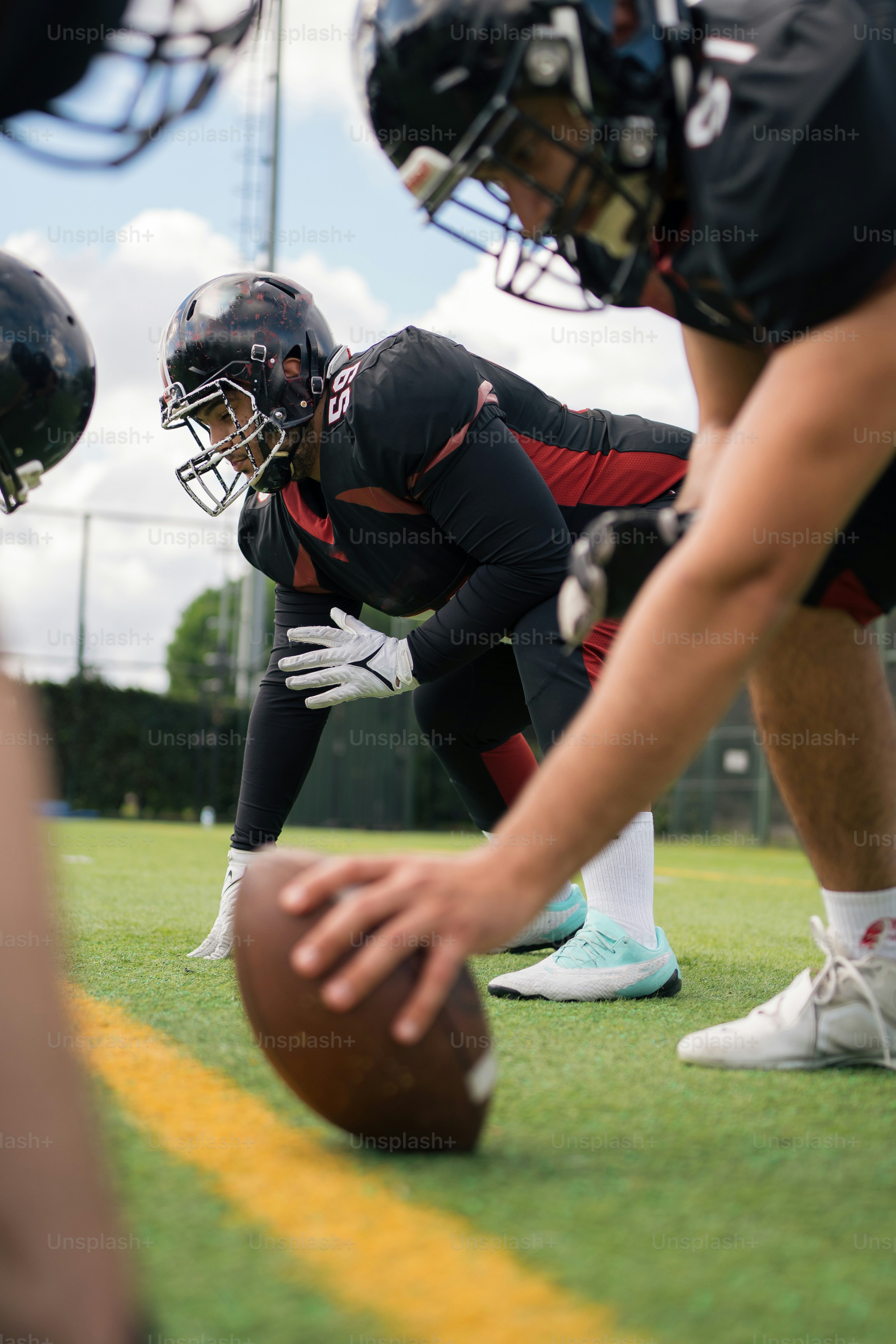 A group of football players standing on top of a field