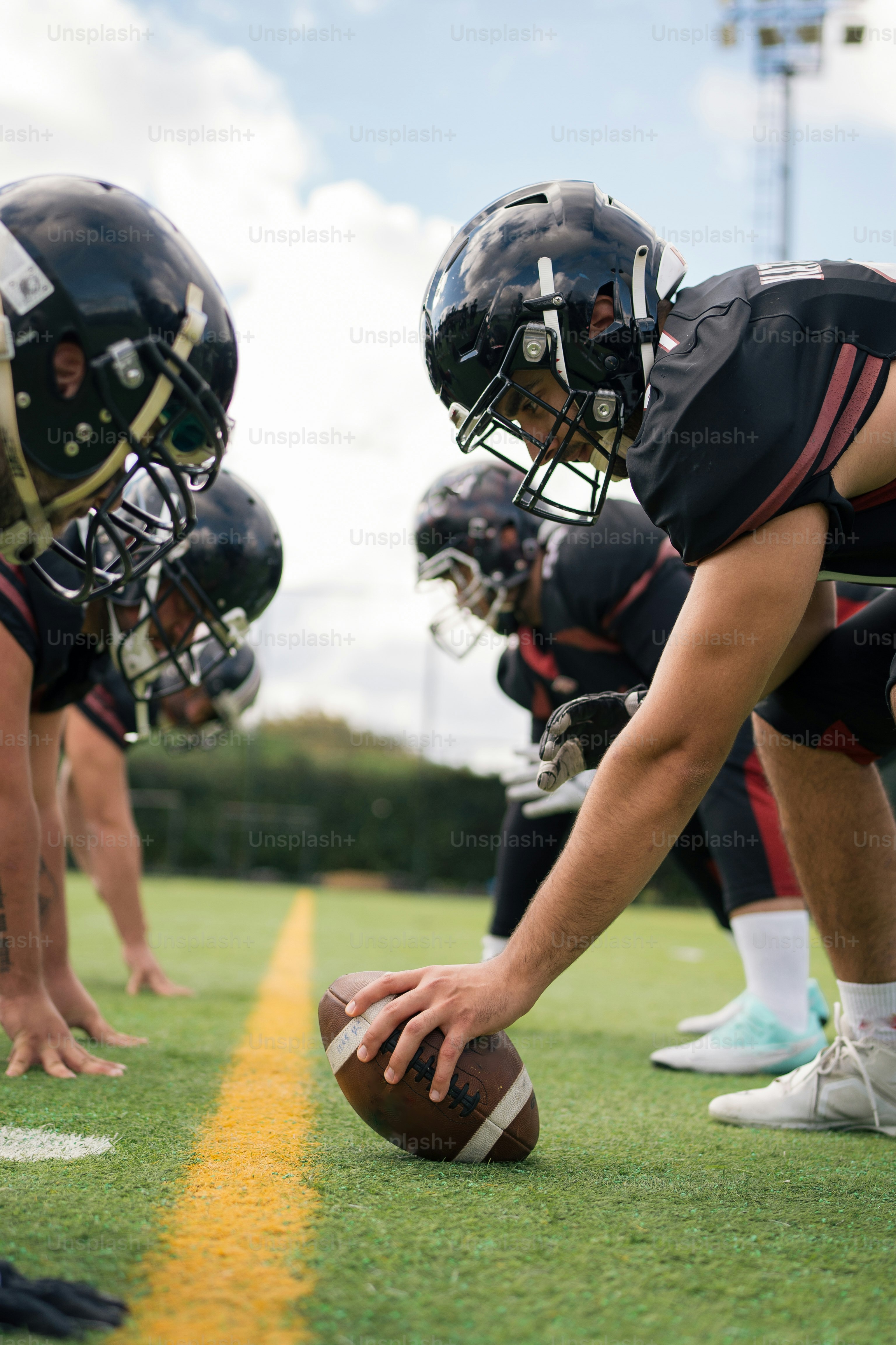 A group of football players standing on top of a field