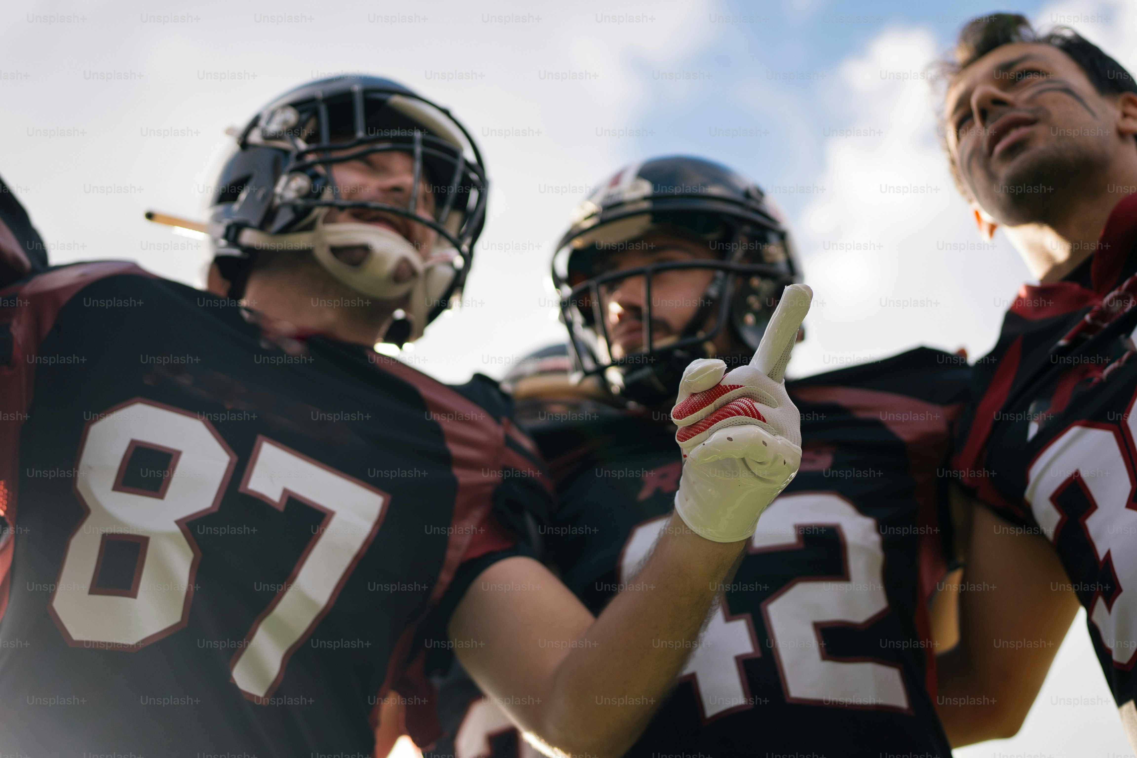 A group of football players standing next to each other