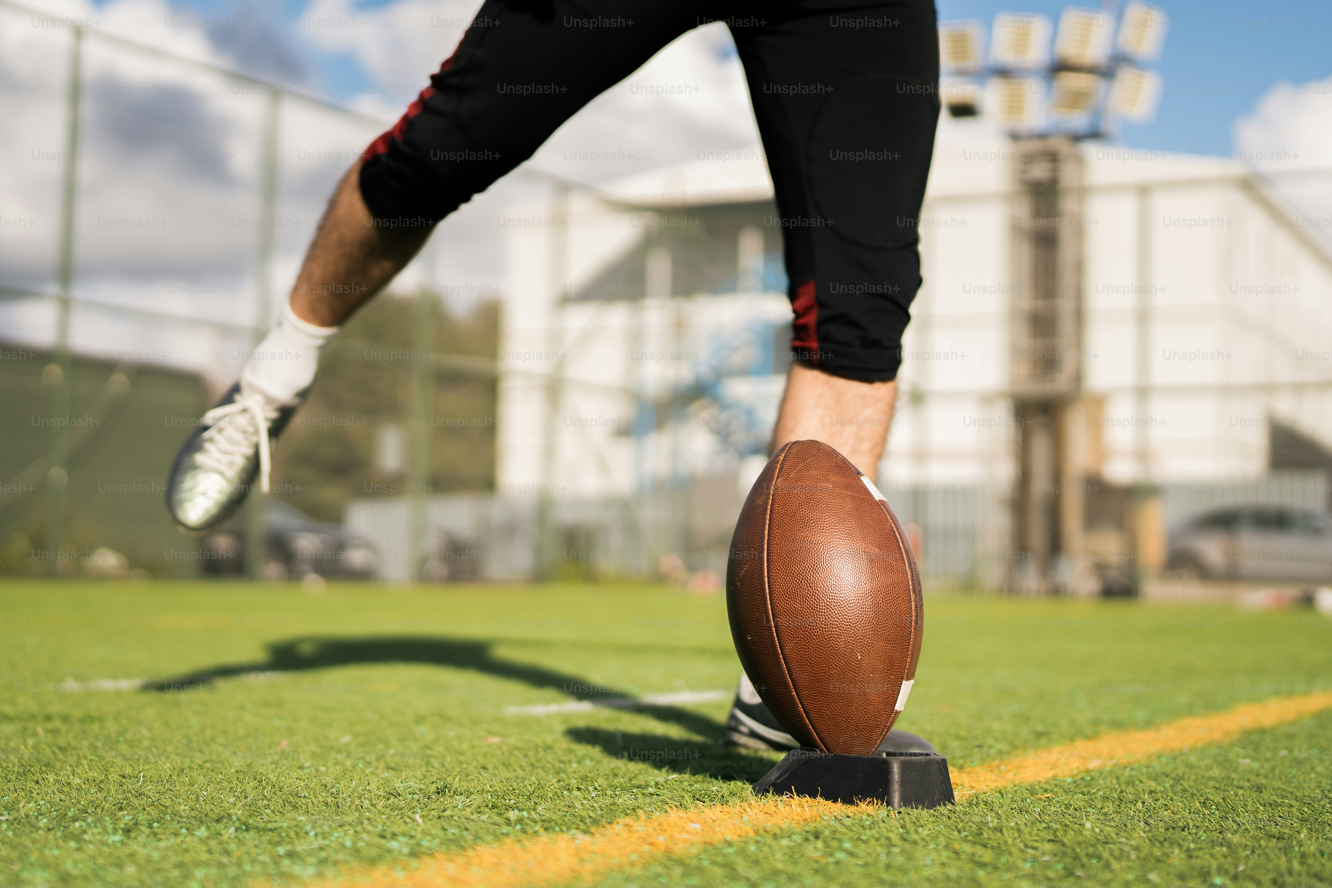 A football player is about to kick the ball