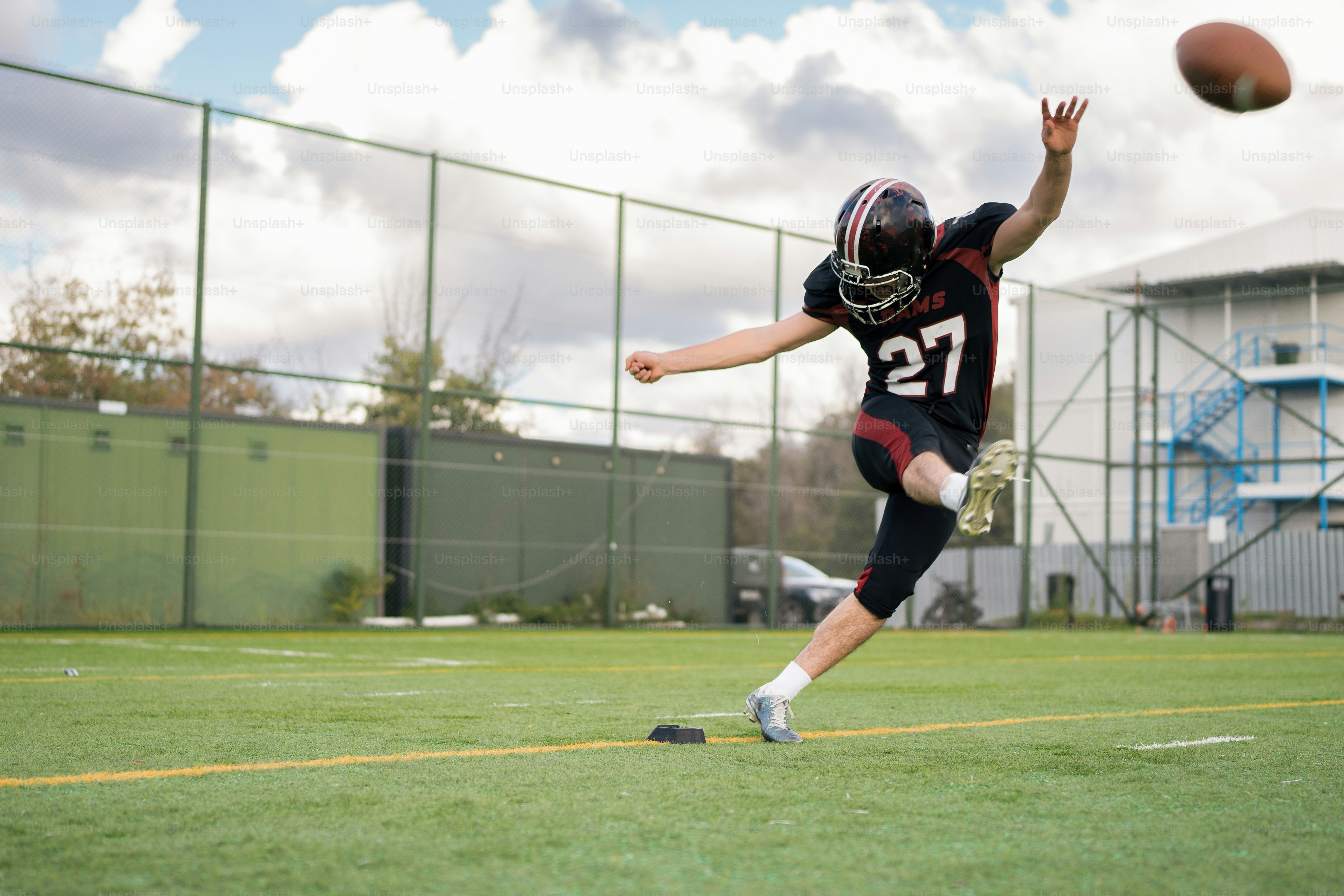A man in a football uniform catching a ball