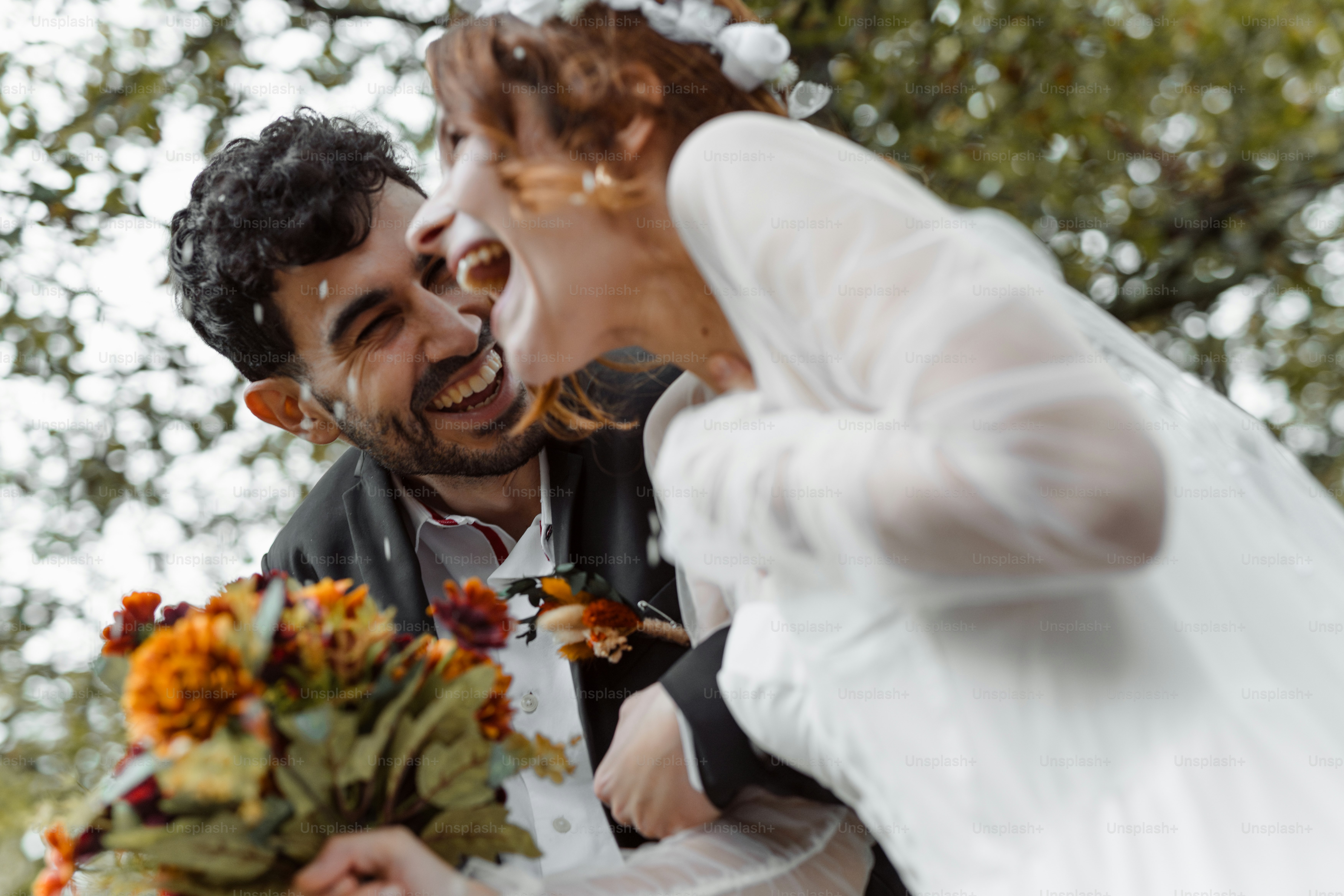 A bride and groom are laughing at each other
