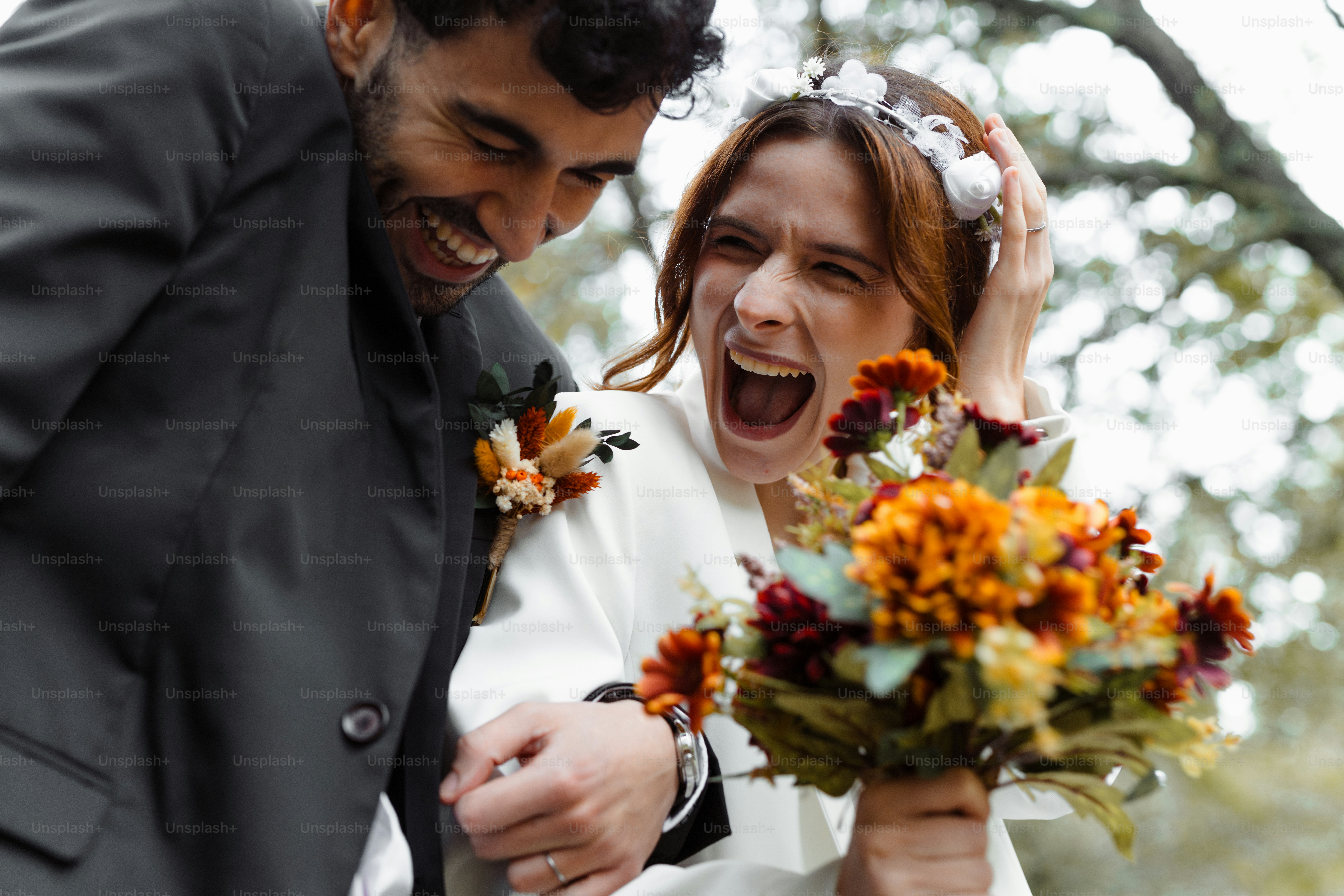 A man and a woman holding a bouquet of flowers