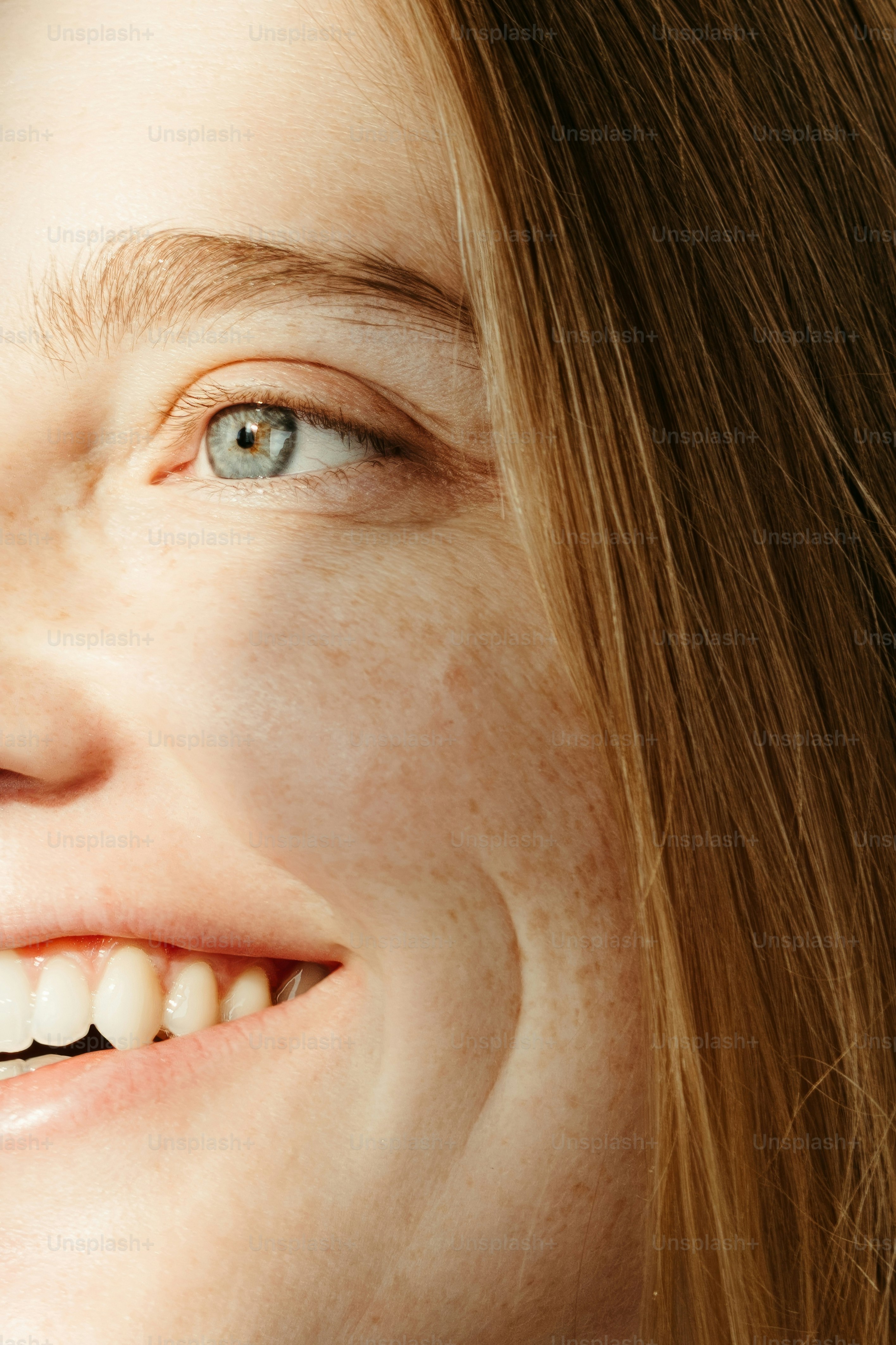 A close up of a woman brushing her teeth