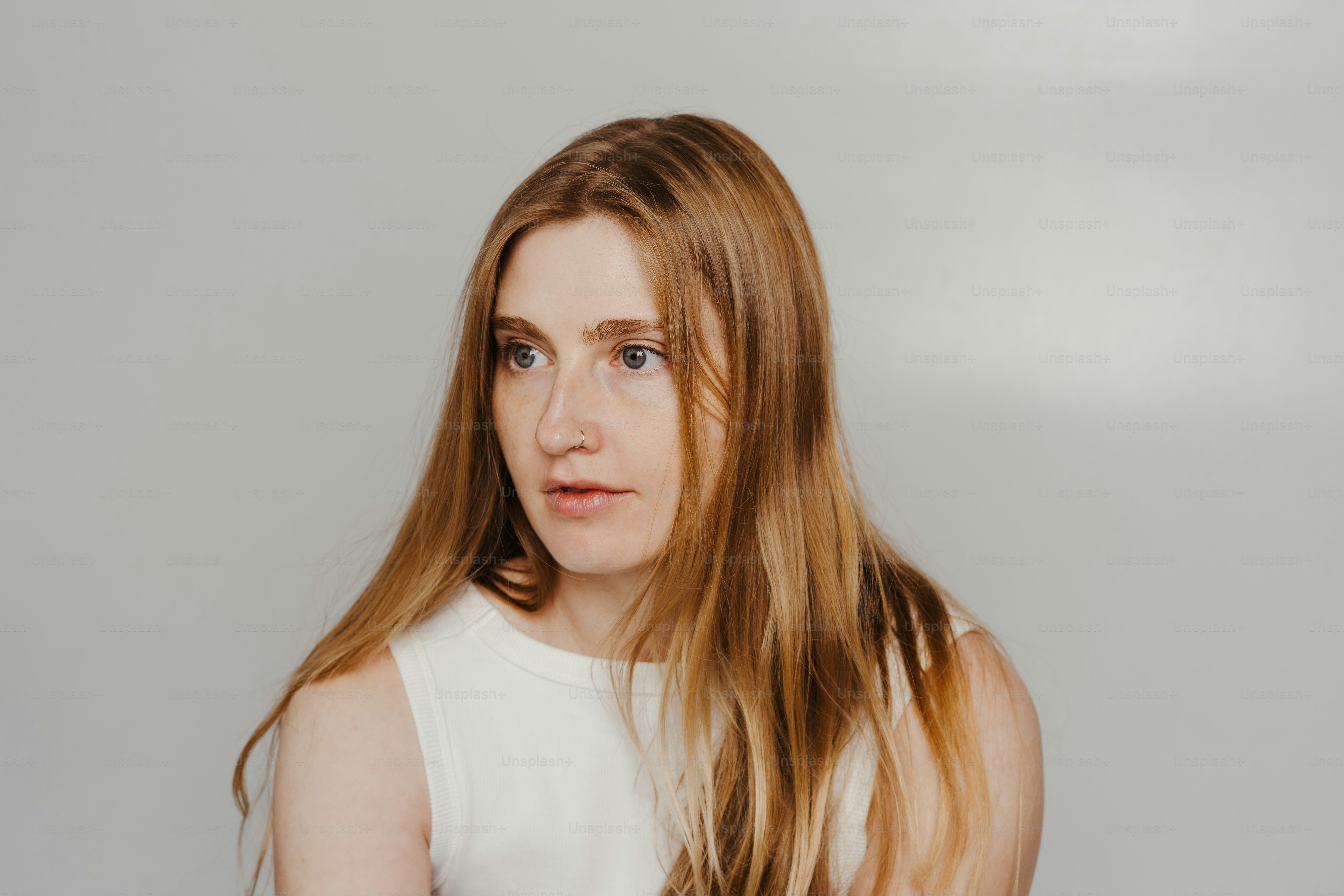 A woman with long hair standing in front of a wall photo – Aesthetic ...