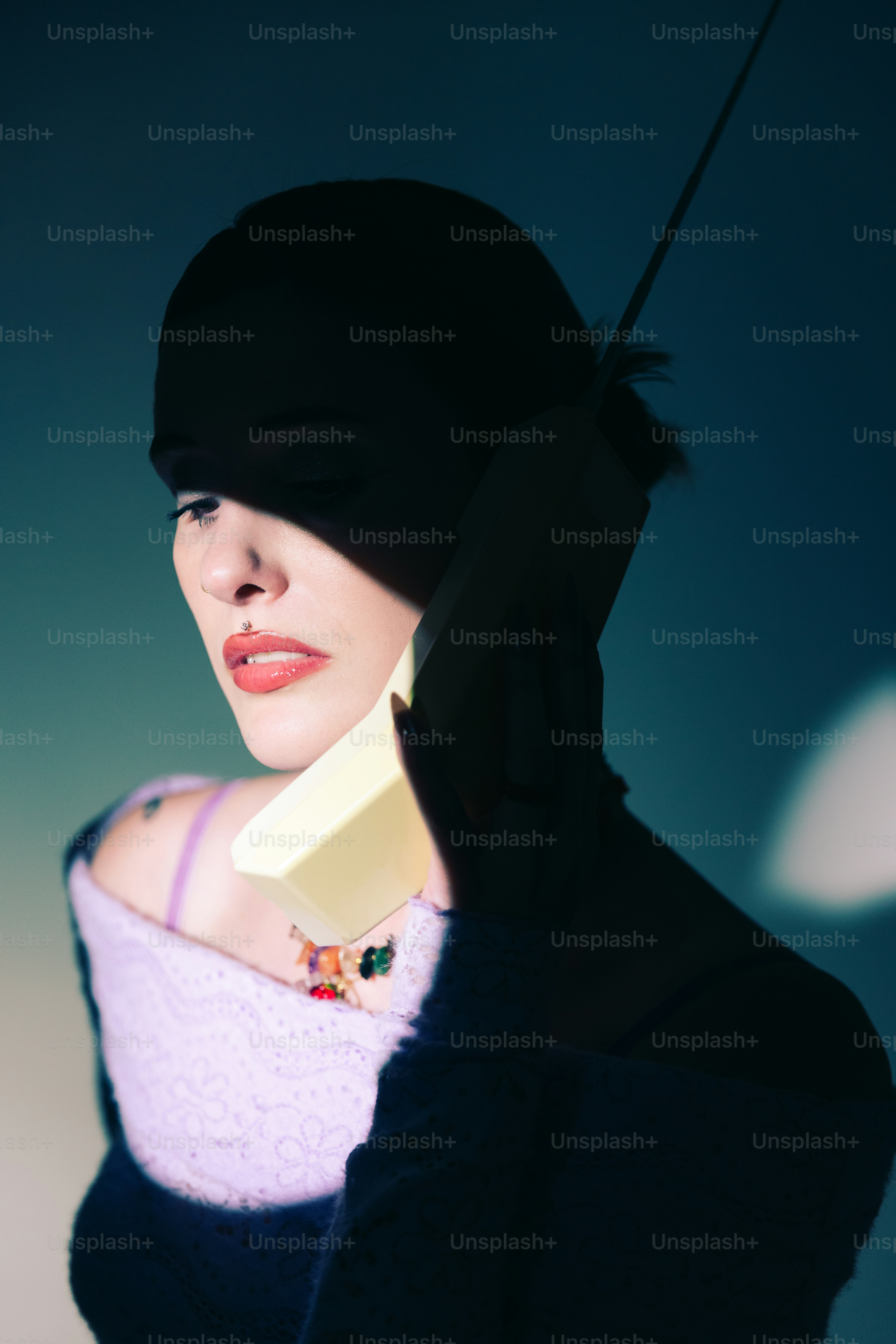 A woman wearing a black hat and a purple sweater