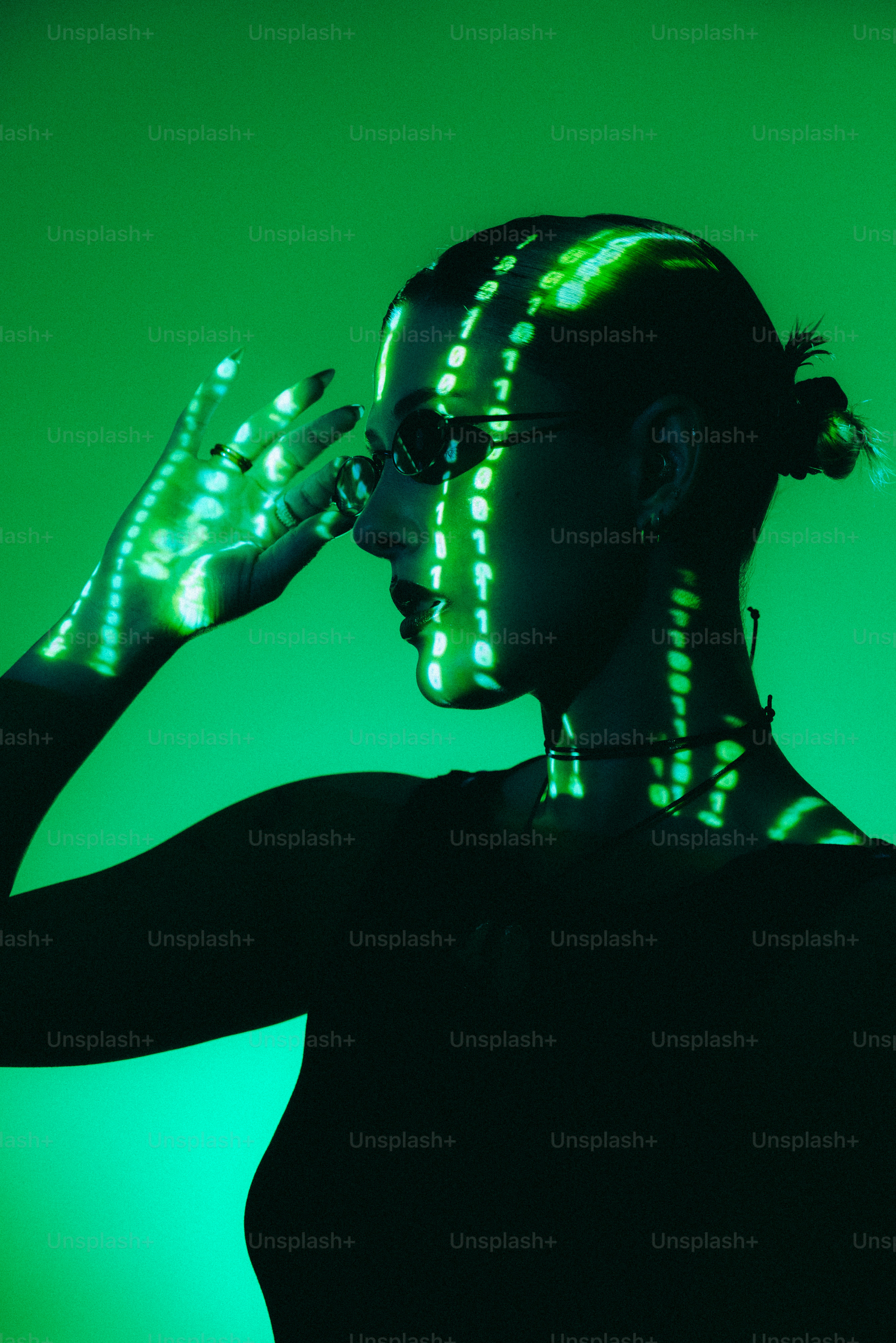 A woman in a black shirt is holding her hands up to her face