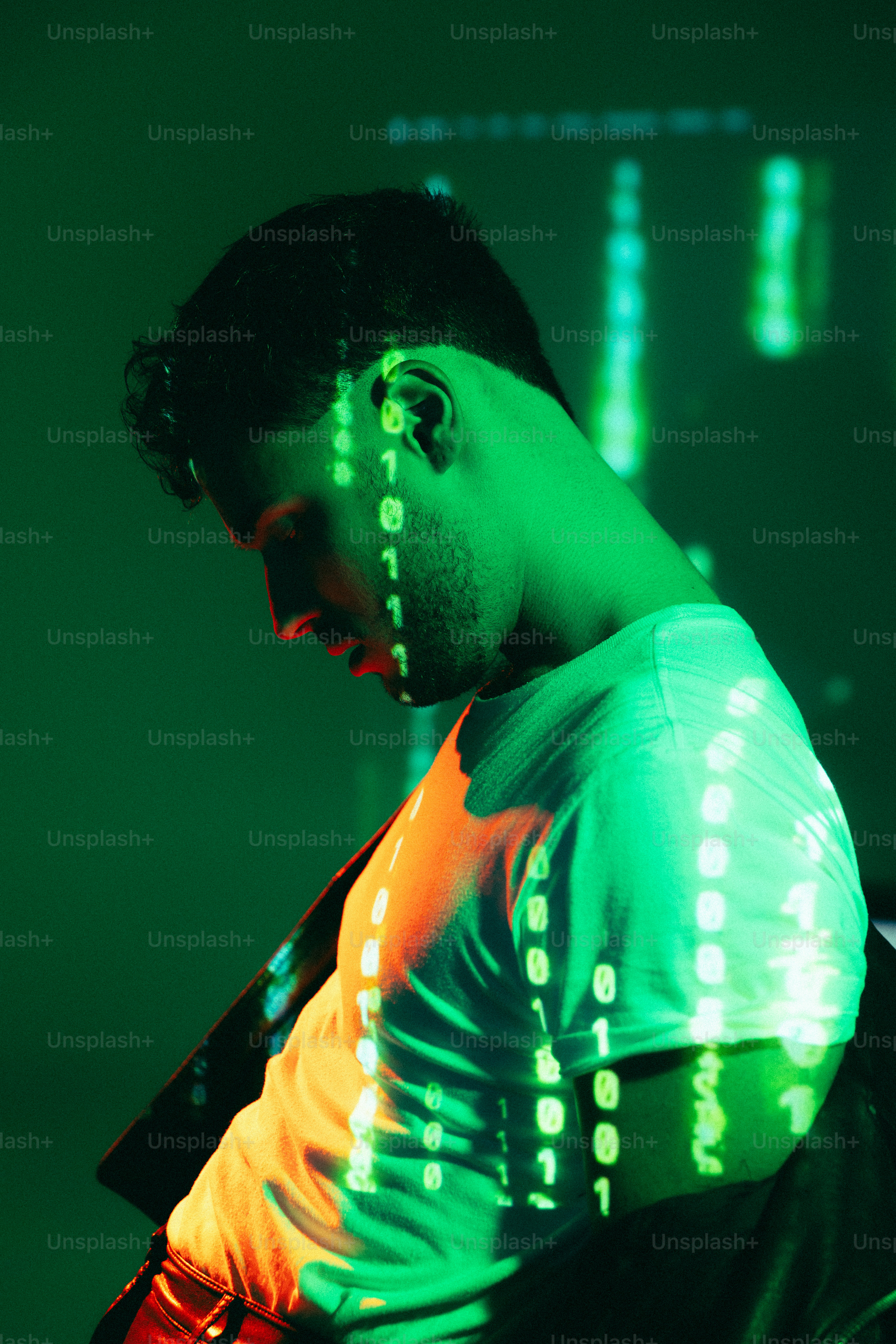 A man standing in front of a green light photo – Y2k Image on Unsplash