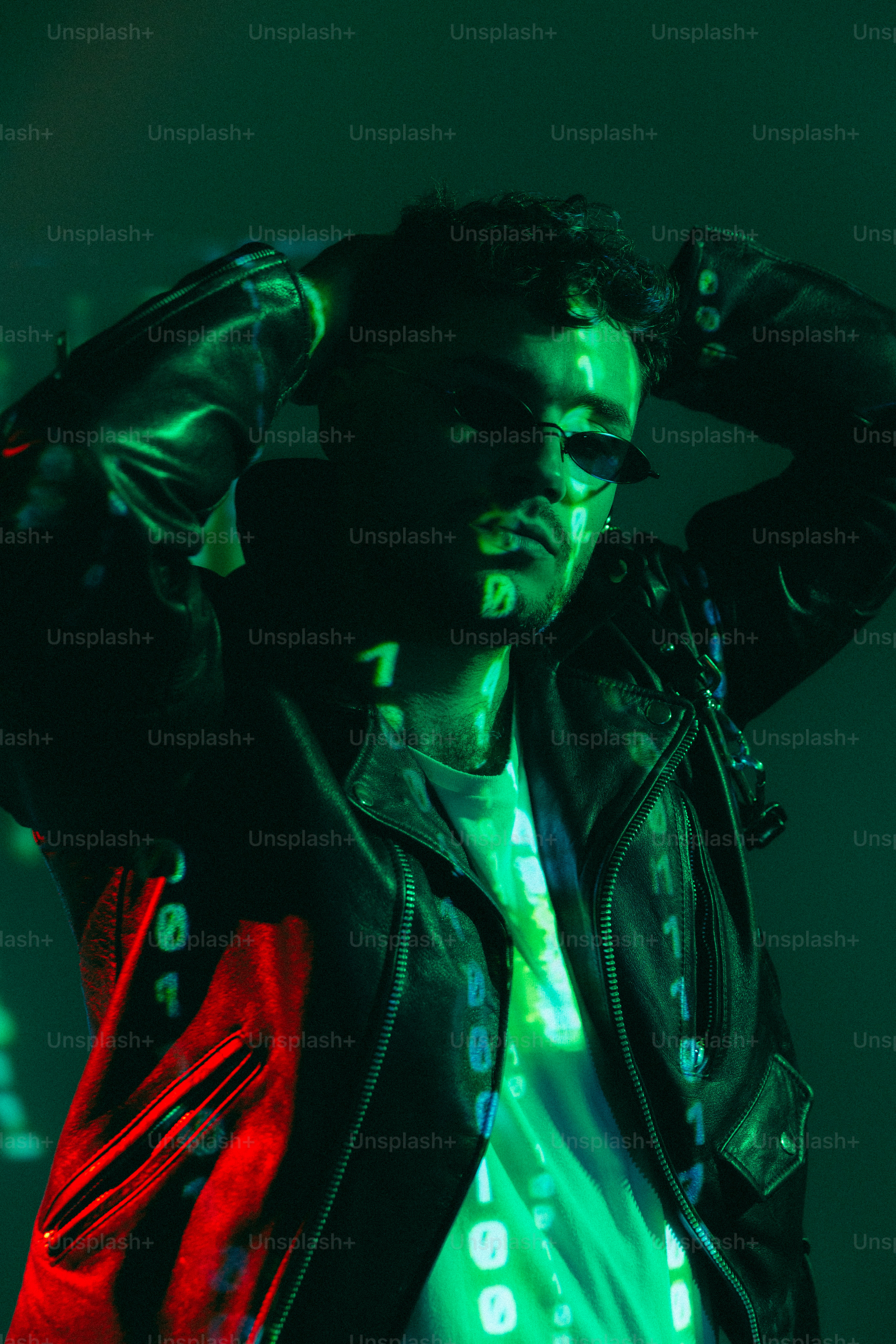 A man in a black leather jacket and a red and green jacket