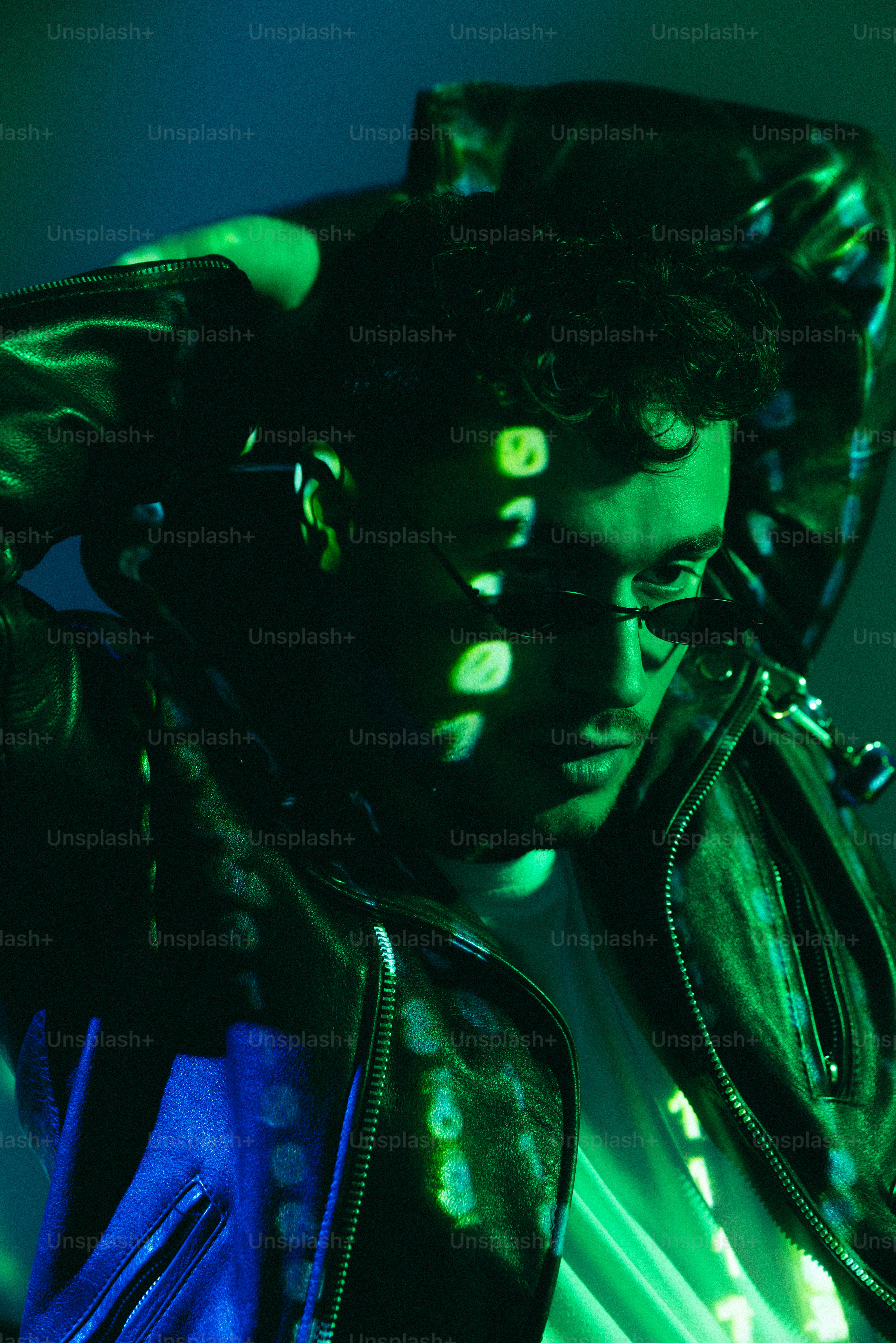 A man wearing a leather jacket and glasses