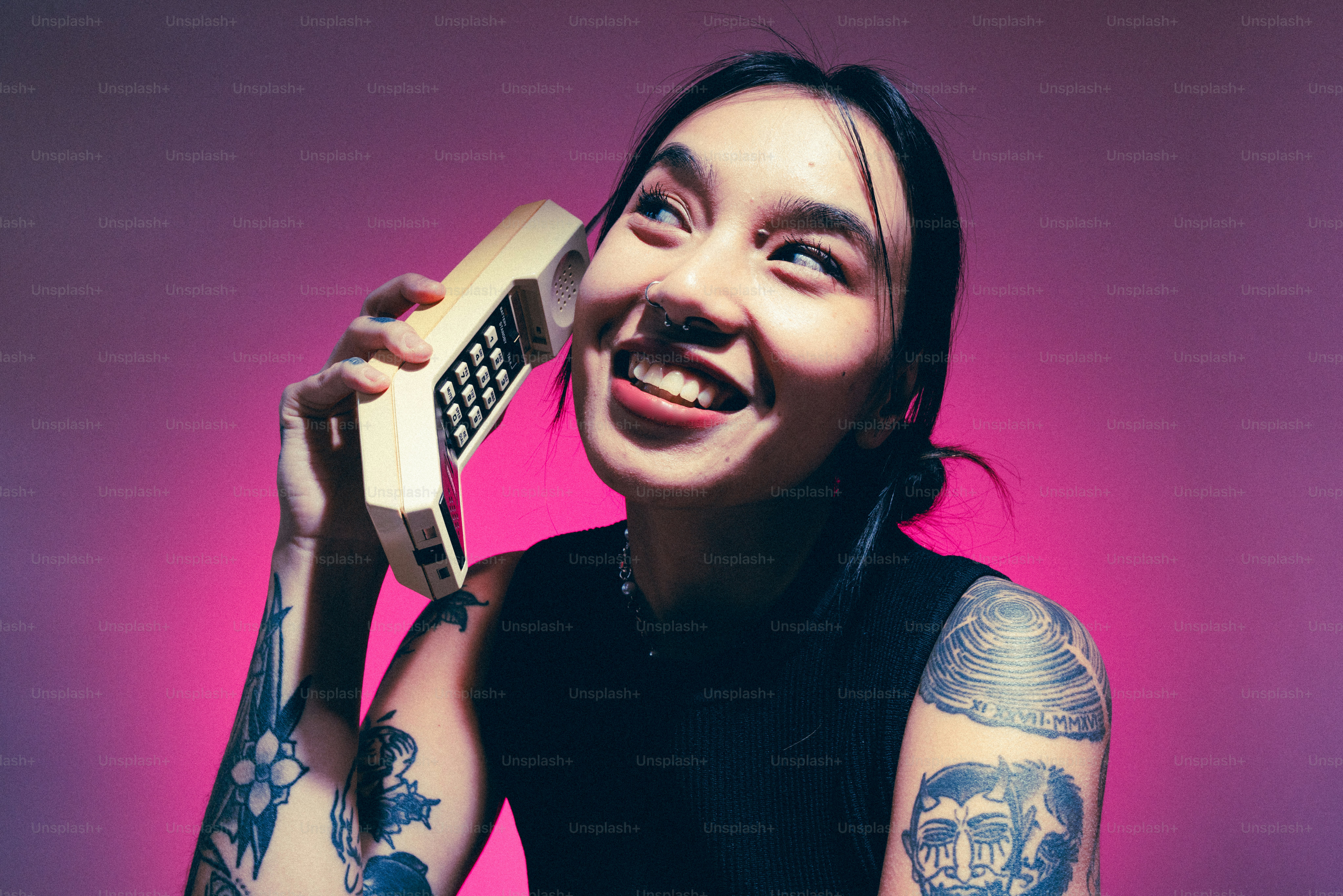 A woman holding a cell phone up to her face