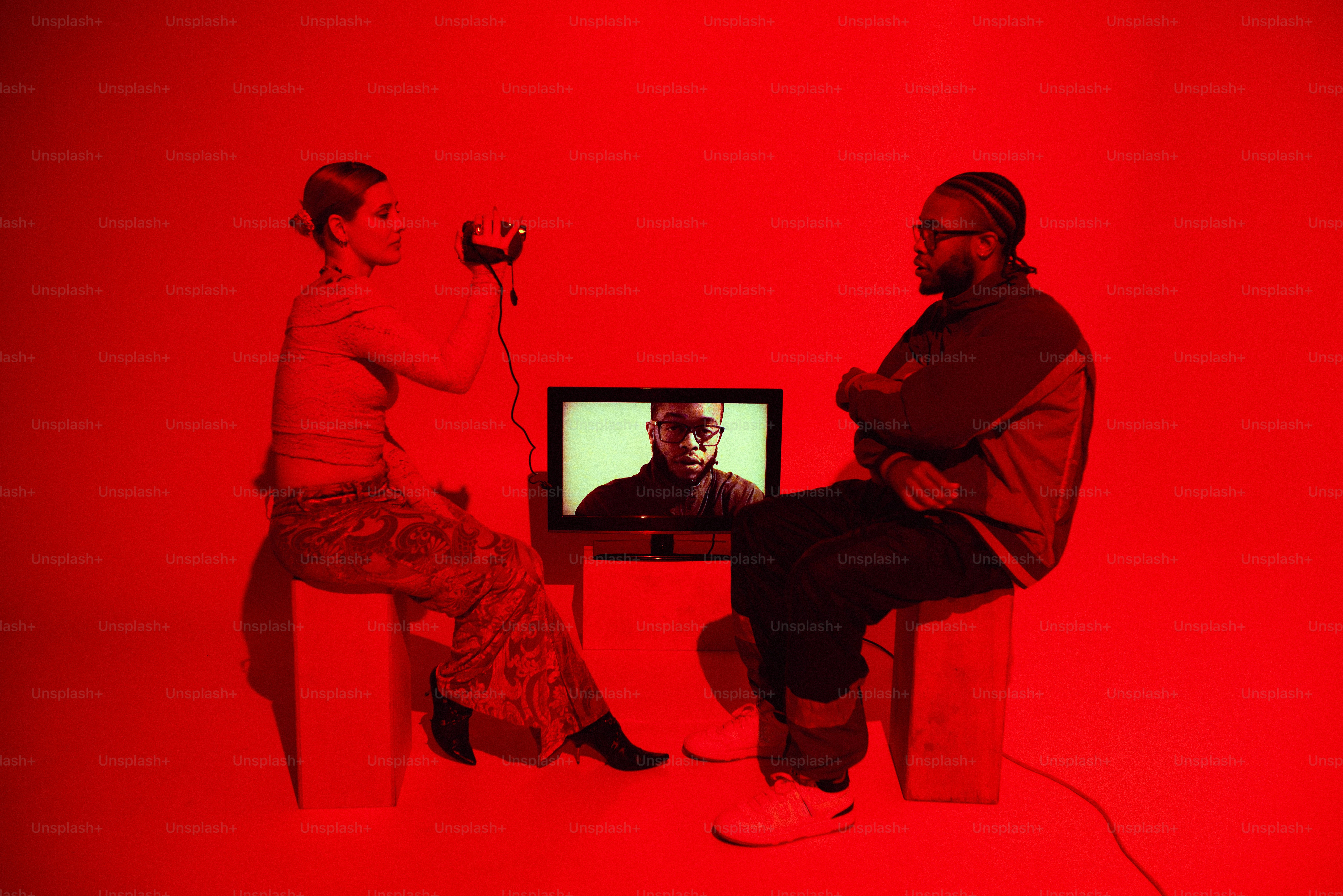 A couple of people sitting in front of a TV