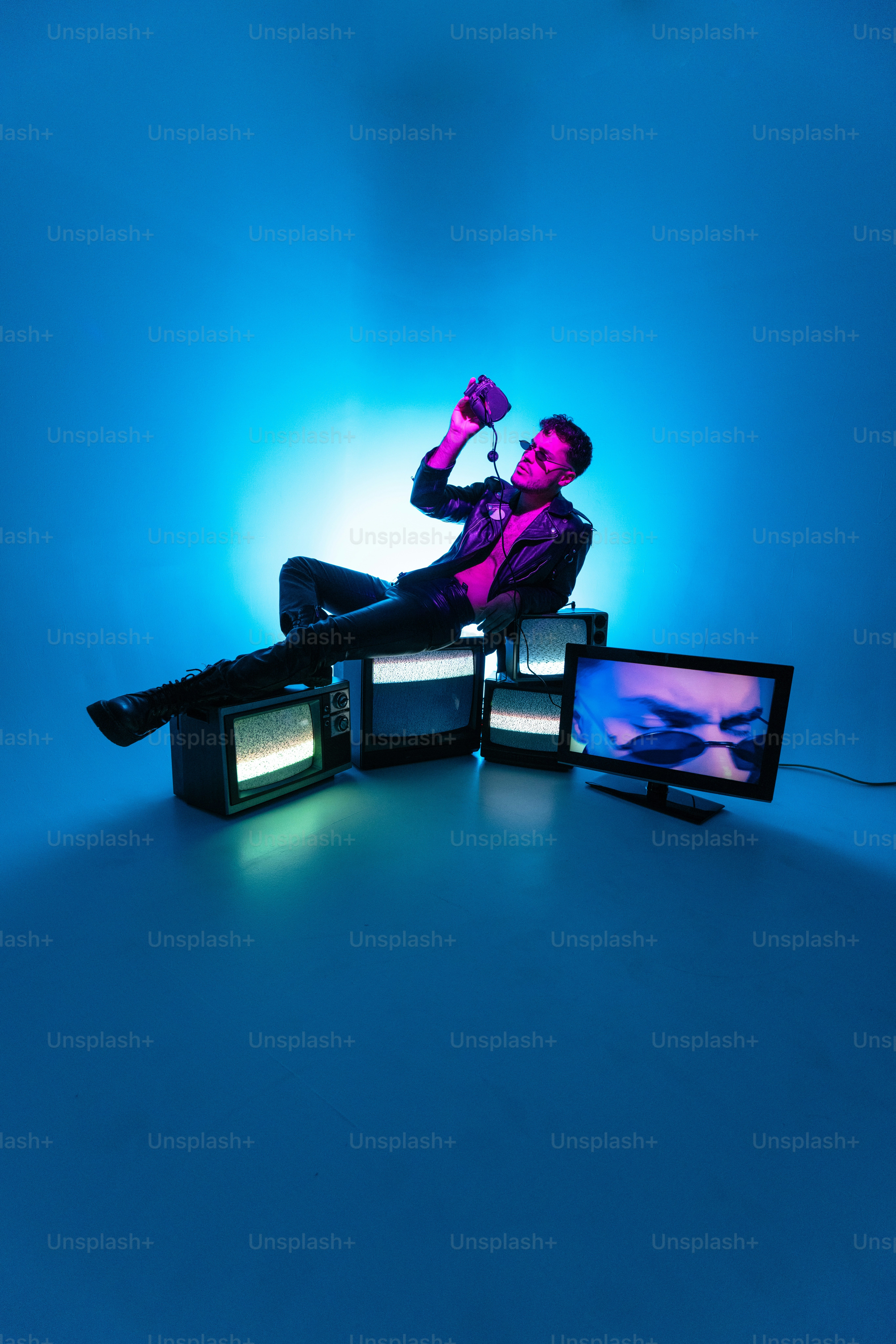 A man sitting on top of a TV set